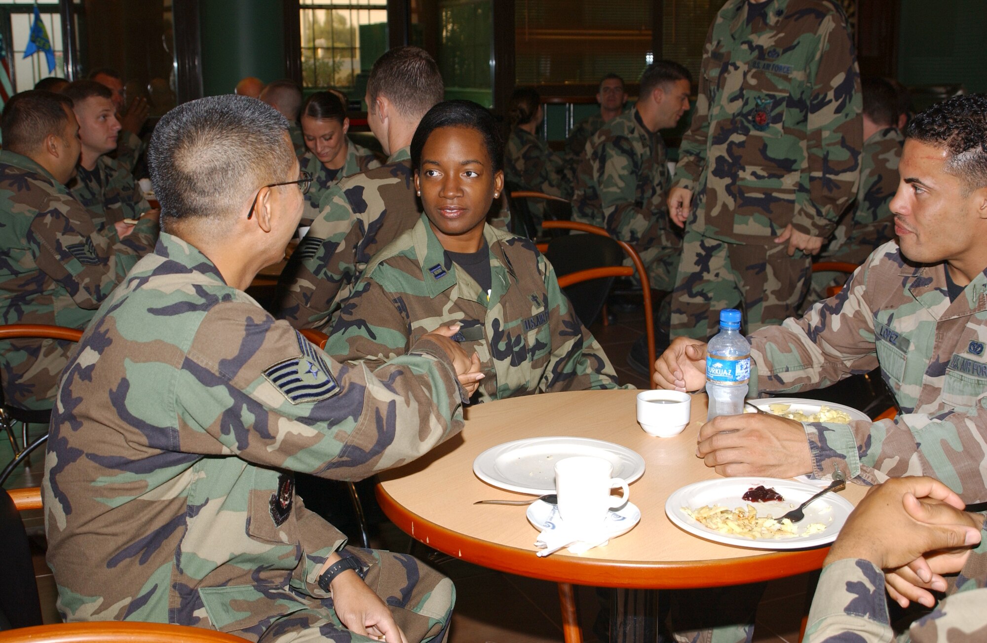 Chaplain (Capt.) Crystal Jones, (center) 39th Air base Wing Protestant chaplain, greets Tech Sgt.Ernie Ednacot, left, and Staff Sgt. Edwin Lopez, both with the 39th Civil Engineer Squadron, before their commander's call at the club Aug. 29. (U.S. Air Force photo by Airman 1st Class Tiffany Colburn)