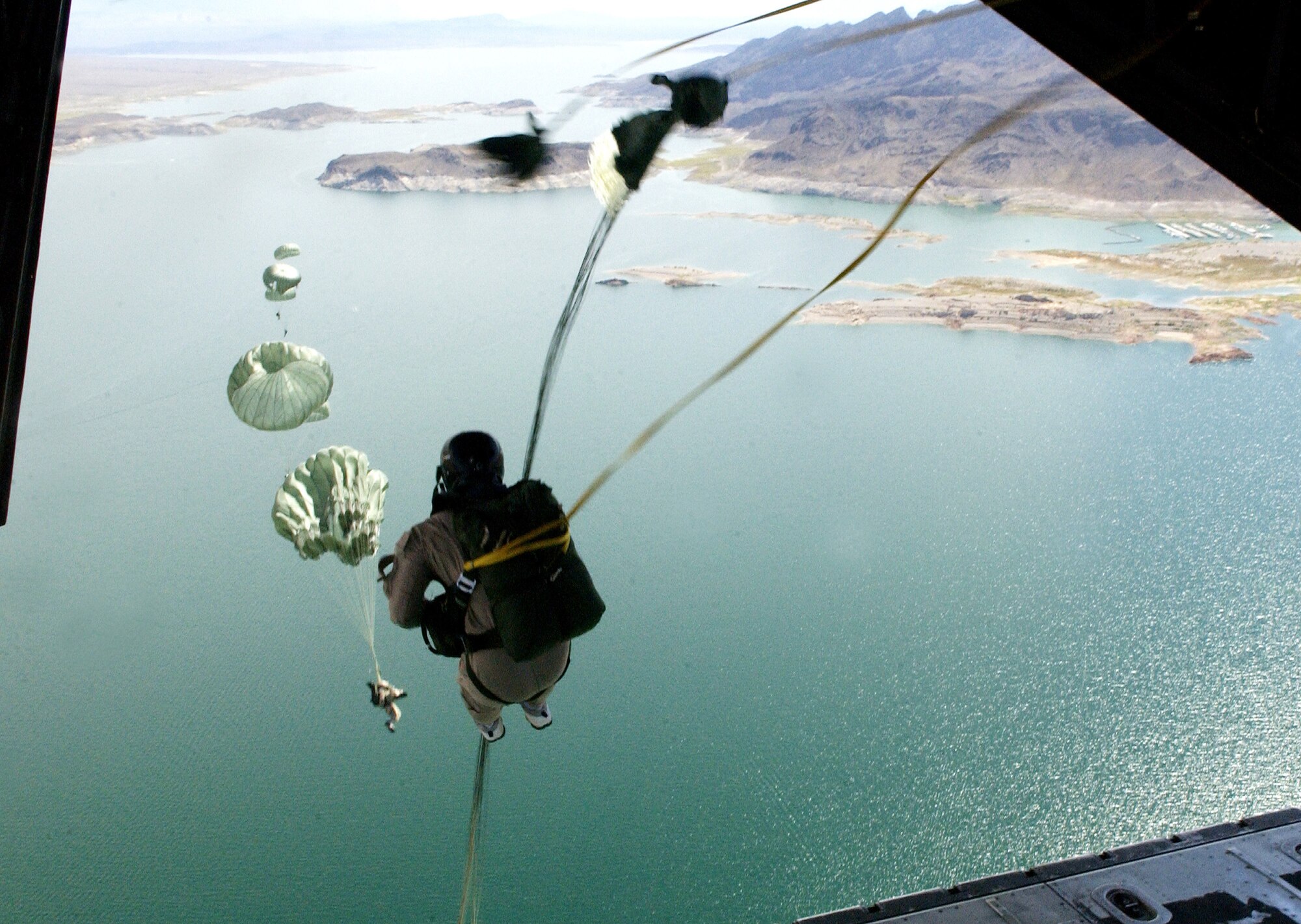 58th Rescue Squadron pararescuemen and combat controllers assigned to the 414th Combat Training Squadron, Nellis Air Force Base, Nev., jump out of a C-130J Hercules Sept. 1, 2006, over Lake Mead in support of Red Flag Exercise 06-2.
(U.S. Air Force photo by Master Sgt. Kevin J. Gruenwald) 

