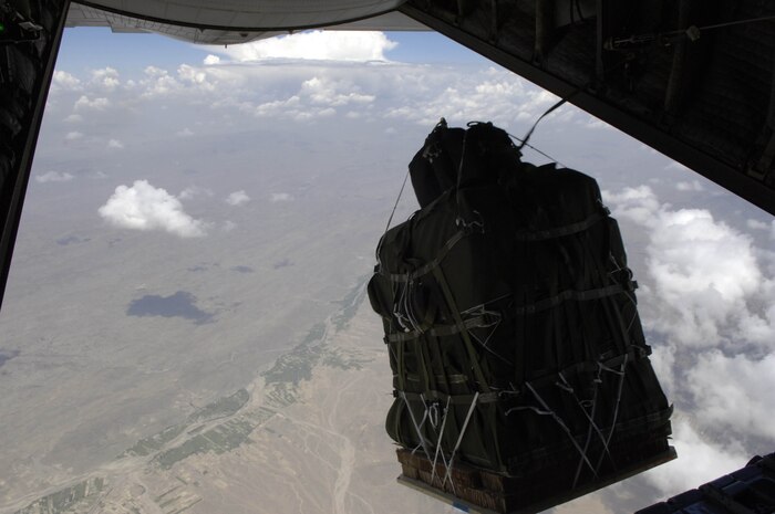 The new GPS guided Screamer 2K bundle, Joint Precision Air Drop System, fall out of the back of a C-130 Hercules over Afghanistan Aug. 26, 2006.  The drop was made from 17,500 feet above mean sea level, and was the first joint Air Force Army operational drop of JPADS in the Central Command Area of Responsibility.  Four bundles were dropped from the Alaska Air National Guard C-130.  The system is designed to provide precision airdrops from high altitudes, elimination the treat of small arms fire.  All four bundles arrived at the drop zone, less than 25 meters from the desired target.    (U.S. Air Force photo/Senior Airman Brian Ferguson)