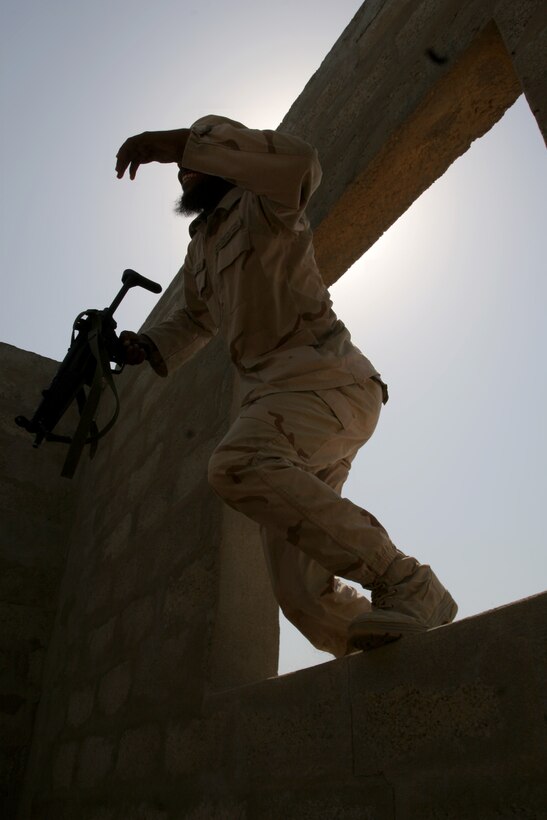 A Saudi Arabian Marine climbs through a window during training in a mock urban environment. Marines from Company B, BLT 1/4, 11th MEU (SOC) conducted Nautical Union, a bilateral training exercise with the Saudi Arabia Marines, June 2-8.