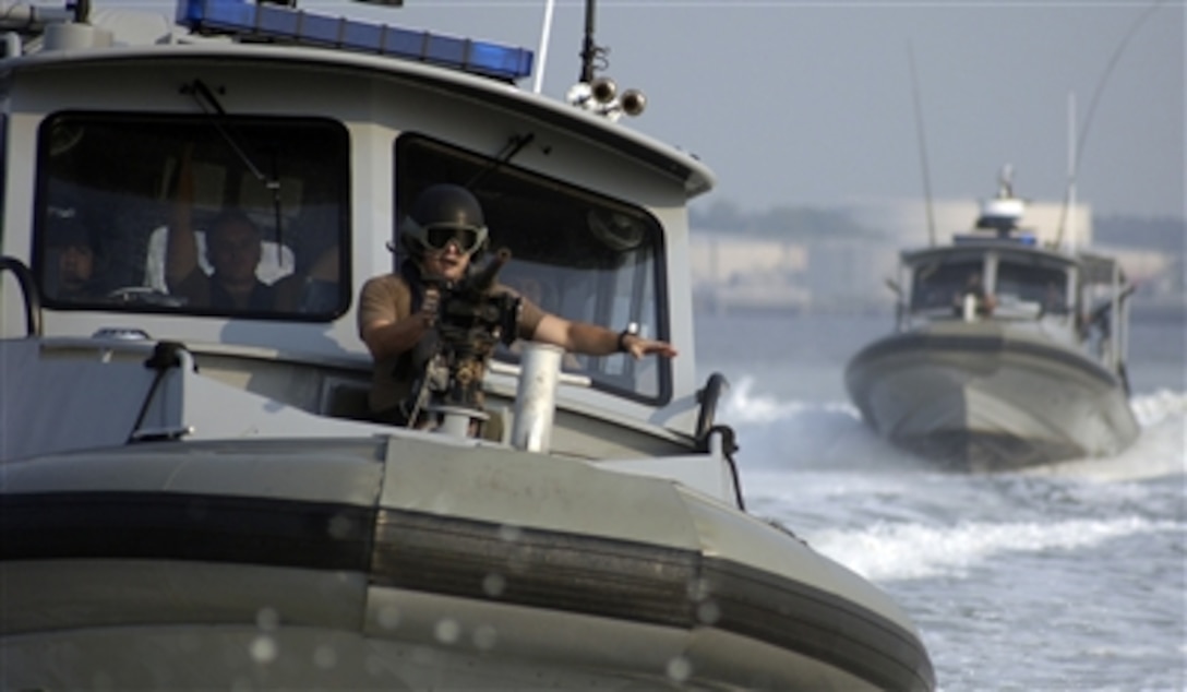 U.S. Navy sailors from the Navy Expeditionary Combat Command perform
high-value asset escort training aboard Inshore Boat Units 41 and 42 from
Naval Coastal Warfare Squadron 4 at Naval Station Norfolk, Va., Aug. 25,
2006. The training is the final test for level-two combat coxswains and
gunners to qualify for handling small, weapons-capable boats in defense of
naval vessels transiting narrow waterways. 
