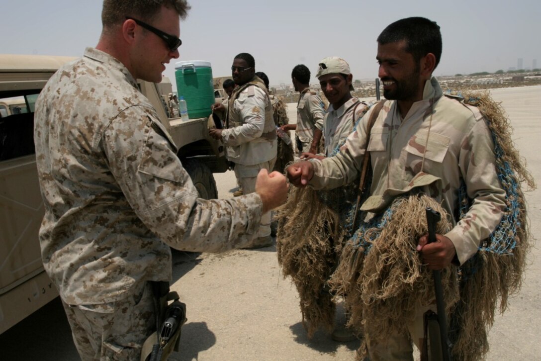 Lance Cpl. Ward A. Kruse, scout sniper, scout sniper platoon, says goodbye to a fellow Saudi Arabia sniper after taking part in Nautical Union, a week-long bilateral training exercise with the Saudi Marines. The training exercise is part of the MEU?s six-month deployment throughout the Western Pacific and Middle East region in support of the Global War on Terrorism.