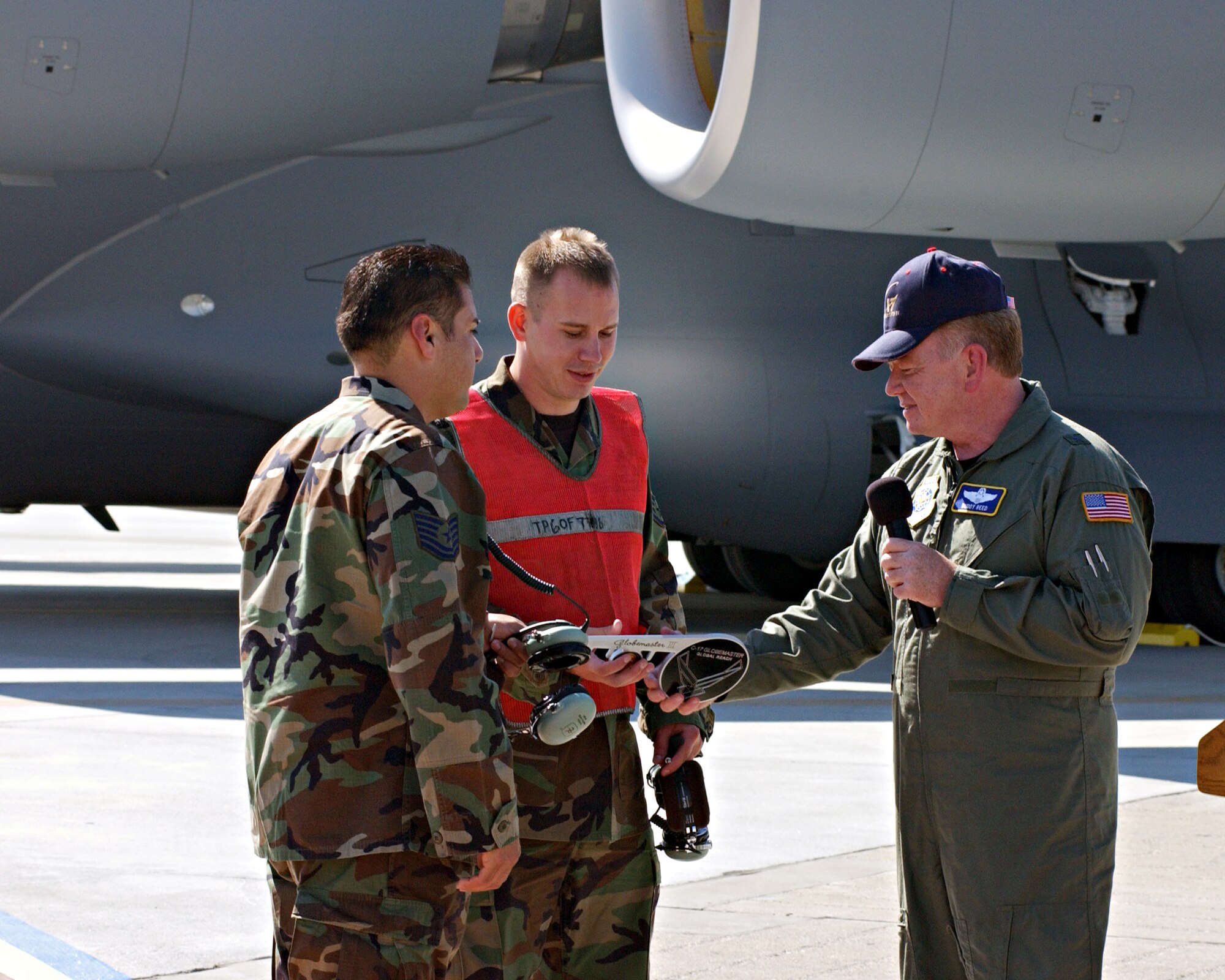 Brigadier Gen. Buddy Reed presents the Key to Travis's newest C-17 to Staff Sgt. Jeffrey Eckert, 860th AMXS and Tech Sgt. Jesus Garza 945th AMXS (Reserve).
The arriving C-17 is the second of thirteen that will be stationed at Travis. Photo by David W. Cushman GS-11