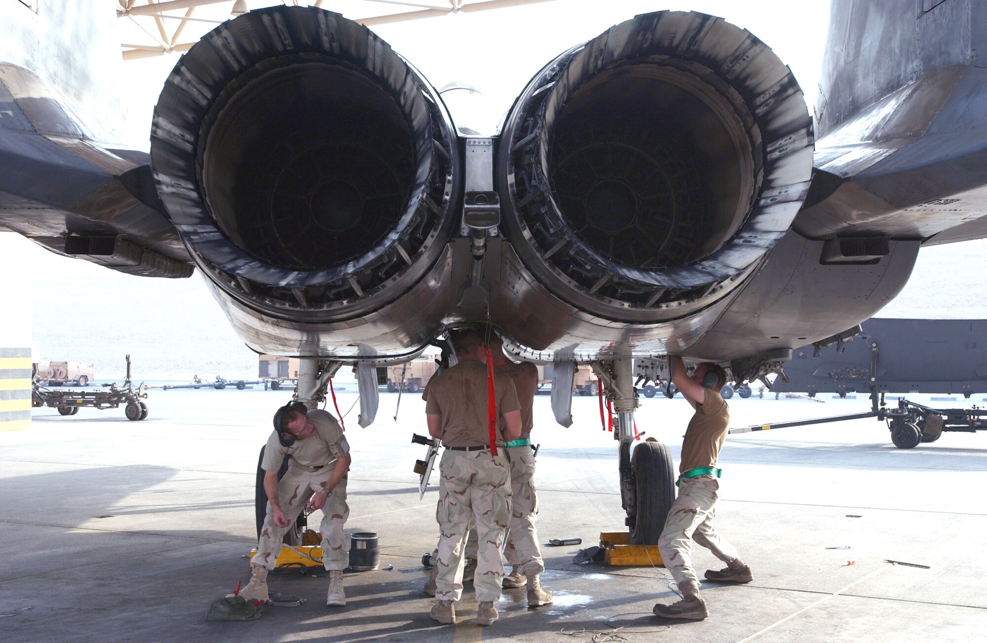 Maintainers from the 335th Aircraft Maintenance Unit at Seymour Johnson Air Force Base, N.C., work on an F-15E Strike Eagle at a forward-operating base in Southwest Asia Sept. 1.  (U.S. Air Force photo/Master Sgt. John DeGroot) 