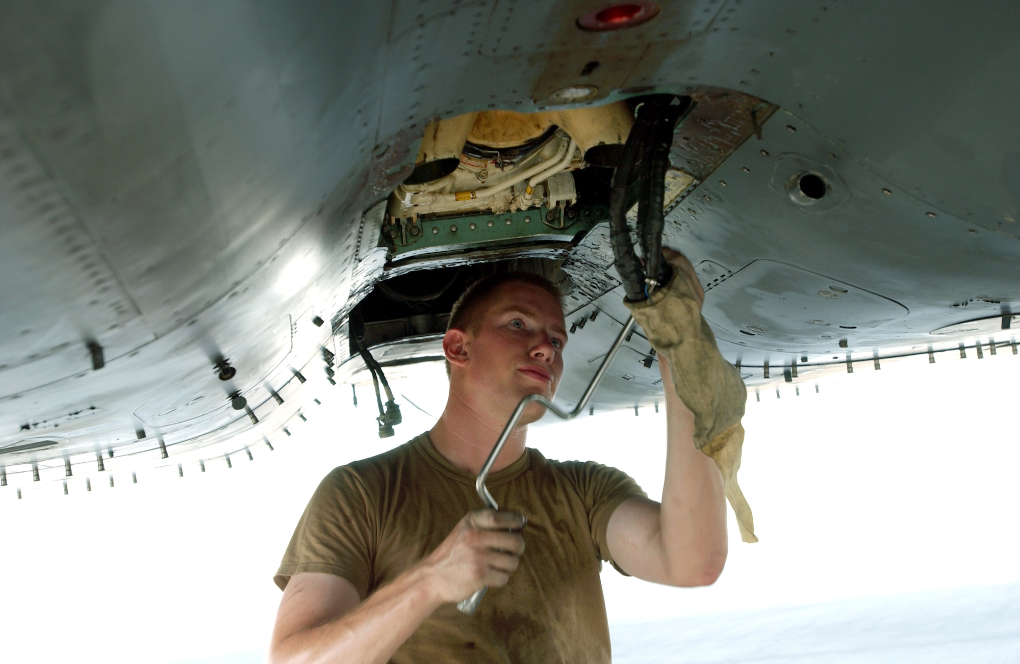 Senior Airman Paul Moore performs a phase inspection on an F-15E Strike Eagle at a forward-operating base in Southwest Asia Sept. 1. Airman Moore is an assistant crew chief deployed from the 335th Aircraft Maintenance Unit at Seymour Johnson Air Force Base, N.C. (U.S. Air Force photo/Master Sgt. John DeGroot) 