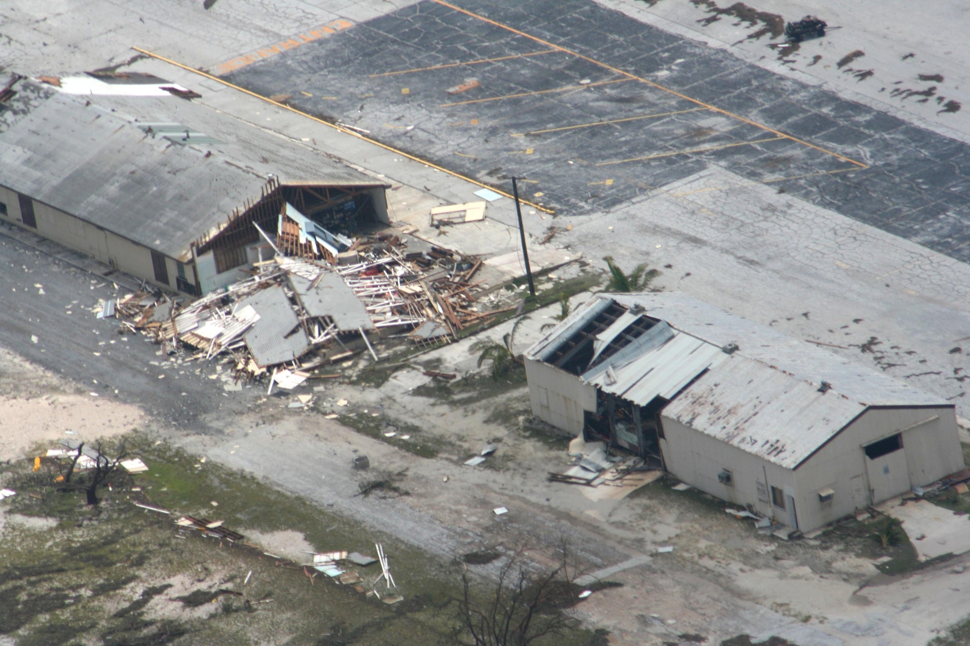 A Sept. 2 flyover of Wake Island by a U.S. Coast Guard aircrew following the passage of Super Typhoon Ioke shows damage to two buildings.  Ships carrying response forces are due to arrive at the island soon. (U.S. Coast Guard photo)