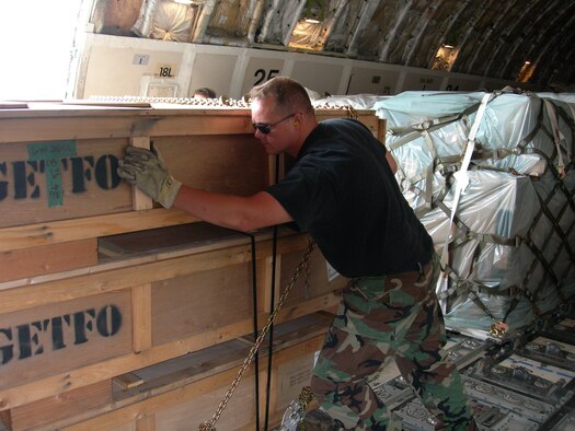 Tech. Sgt. Raymond Edwards pushes pallets of cargo inside of a Boeing 747 during Patriot Partner 2006. Sergeant Edwards and other reservists of the 333rd Consolidated Aerial Port Squadron moved nearly 2,000 tons of cargo, loading and unloading about 300 aircraft (Air Force photo by Staff Sgt. Luis Delmoral).
