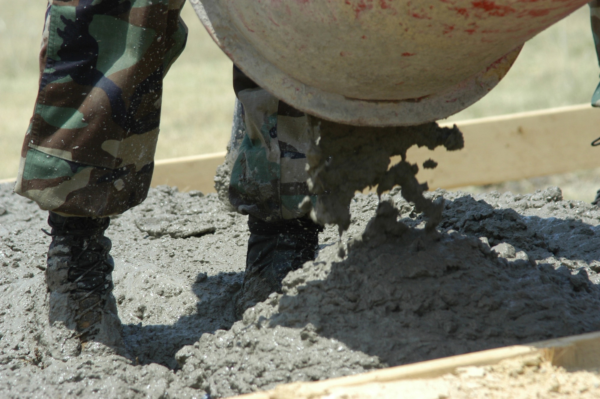 A job done well is worth getting really dirty for. Concrete poured here is for a foundation that will hold the 301st Fighter Wing alert facility's stand-alone generator. (U.S. Air Force Photo/Tech. Sgt. Julie Briden-Garcia)