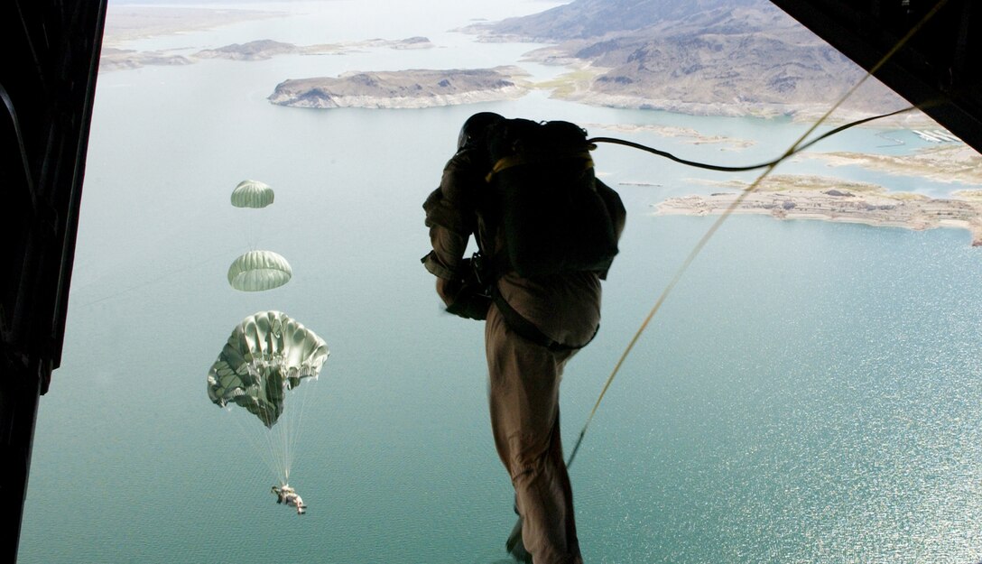58th Rescue Squadron pararescuemen and combat controllers assigned to the 414th Combat Training Squadron, Nellis Air Force Base, Nev., jump out of a C-130J Hercules Sept. 1, 2006, over Lake Mead in support of Red Flag Exercise 06-2.
(U.S. Air Force photo by Master Sgt. Kevin J. Gruenwald) 


