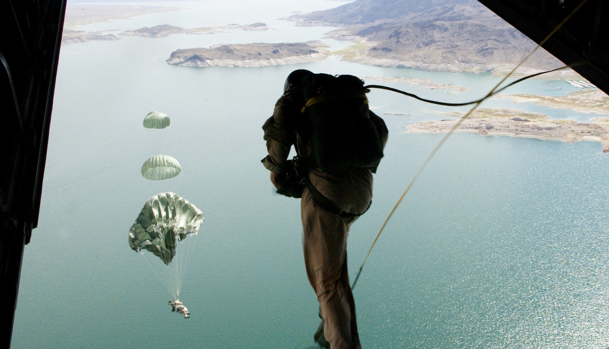 58th Rescue Squadron pararescuemen and combat controllers assigned to the 414th Combat Training Squadron, Nellis Air Force Base, Nev., jump out of a C-130J Hercules Sept. 1, 2006, over Lake Mead in support of Red Flag Exercise 06-2.
(U.S. Air Force photo by Master Sgt. Kevin J. Gruenwald) 


