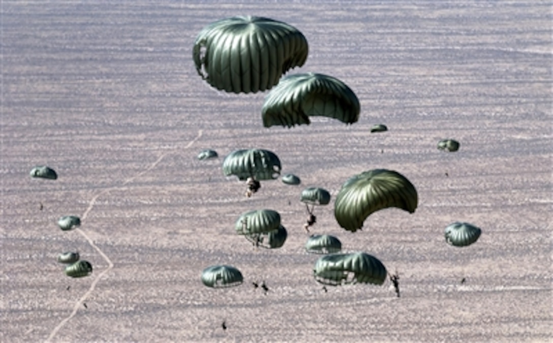 Pararescuemen from the 414th Combat Training Squadron and parachutists from the 820th Red Horse Squadron from Nellis Air Force Base, Nev., jump out of a C-130 Hercules Sept. 1, 2006, over the Nevada Test and Training Ranges in support of Red Flag Exercise 06-2. 