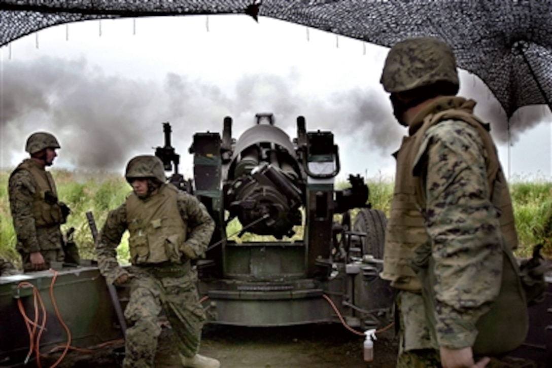 U.S. Marines with India Battery, attached to 1st Battalion, 5th Marine Regiment, the 31st Marine Expeditionary Unit’s Battalion Landing Team, fire a round out of an M-198 155mm Medium Howitzer cannon at Yausubetsu Maneuvering Area, Japan, Aug. 30, 2006, during an artillery live-fire exercise. 