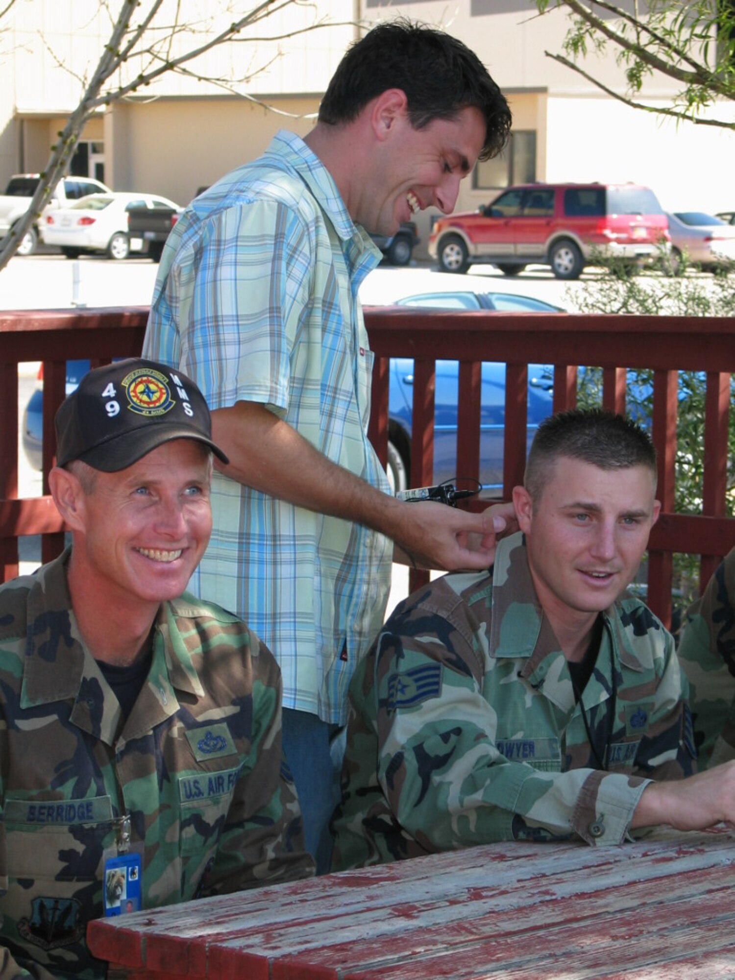 KOAT Channel 7 reporter Mr. Jeffrey DeMars attaches a microphone to Staff Sgt. Robert Dwyer, 49th Mission Support Squadron, prior to an interview about the one-year anniversary of the BEAR Base JTF Katrina deployment. Mr. DeMars covered the deployment as an embedded reporter assigned to the 49th Material Maintenence Group at the New Orleans airport.