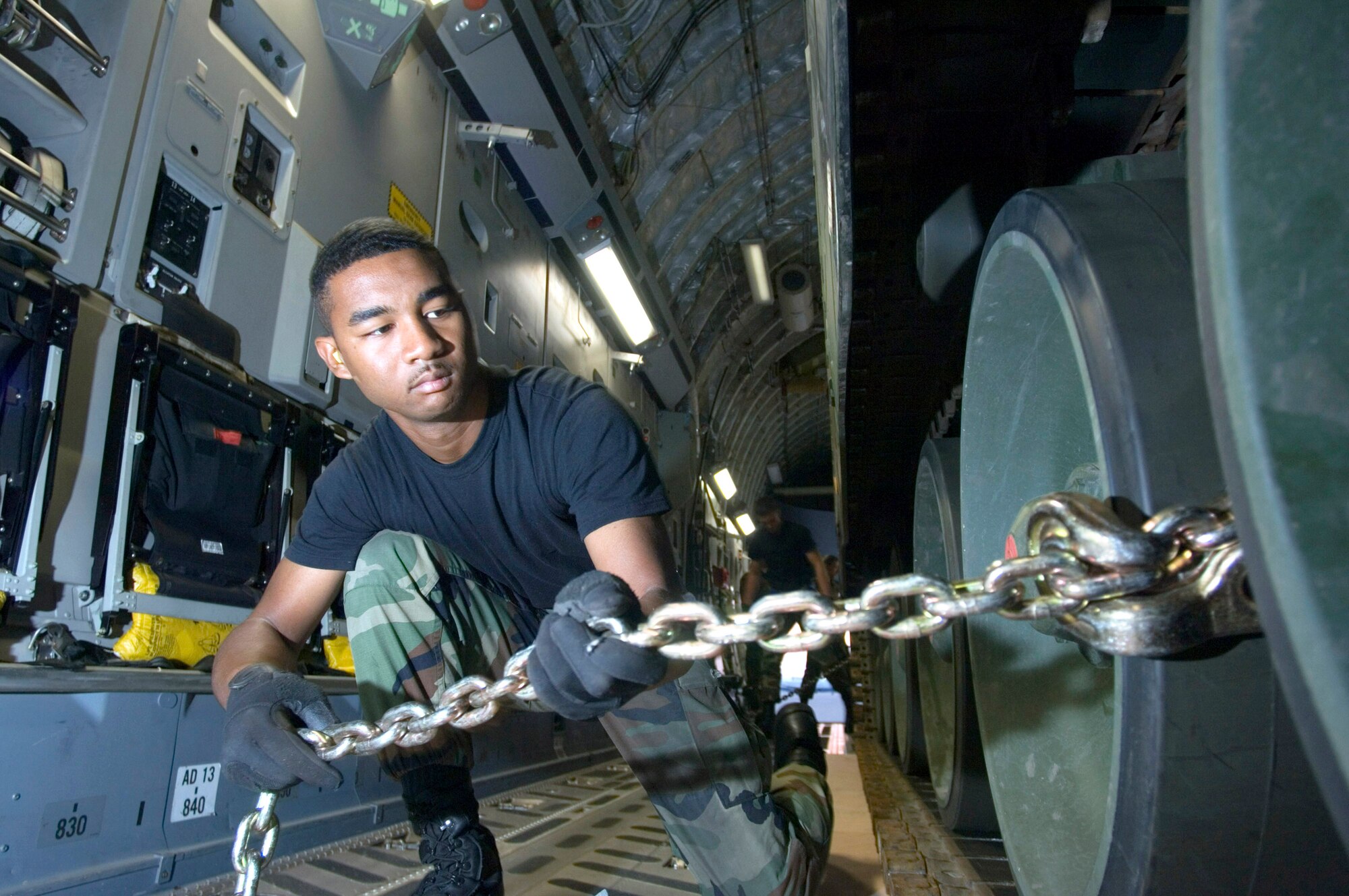 Airman Jason Estell prepares one of the 29 chains used to secure a 60-ton Netherlander Howitzer 2000 on a C-17 Globemaster III at Ramstein Air Base, Germany, Sept. 6. Airman Estell is an air transportation specialist with Ramstein's 723rd Air Mobility Squadron. (U.S. Air Force photo/Master Sgt. John Lasky) 
