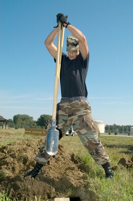 GRISSOM AIR RESERVE BASE, Ind -- Working on a horseshoe pit to improve the area behind the Grissom Inn, Senior Airman Shawn Colaizzi, 434th Civil Engineering Squadron, slams down a post-hole digger. The 434th CES is currently working on several projects to help improve facilities offered to those on base. One such project is a softball diamond also being built behind the inn. (U.S. Air Force photo/ SrA. Mark Orders-Woempner)