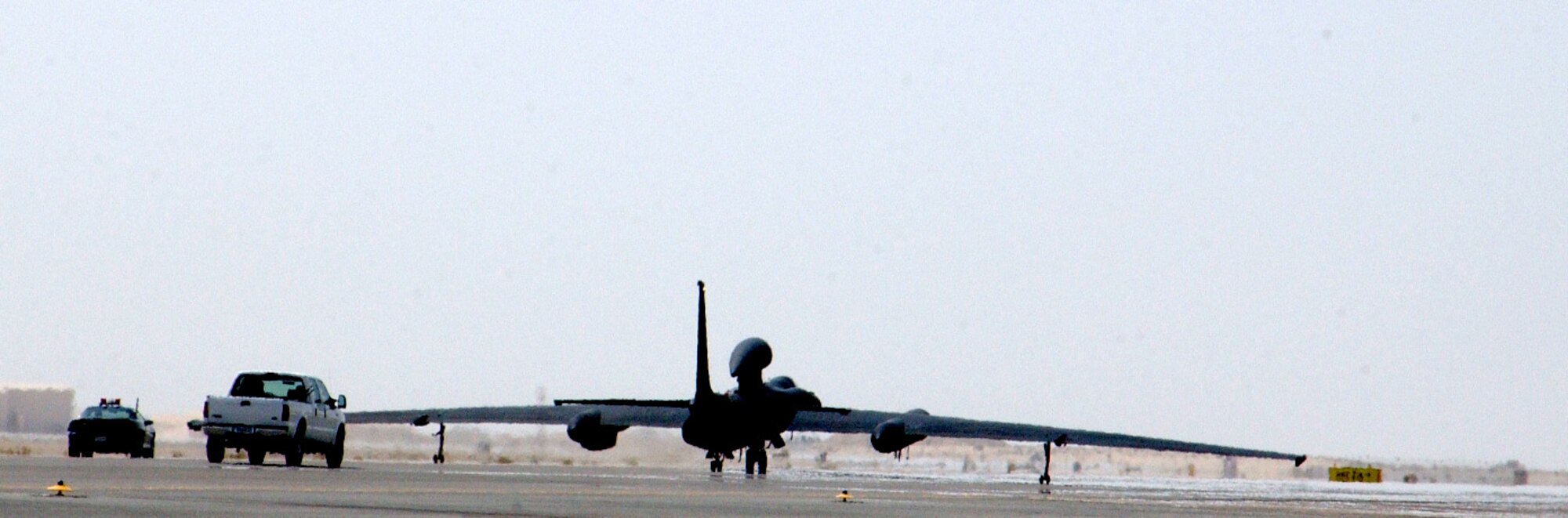 A U-2 piloted by Capt. Greg Hafner rolls toward takeoff followed by its chase car and other vehicles at a forward-operating base in Southwest Asia Sept. 5. The captain is assigned to the 99th Expeditionary Reconnaissance Squadron. (U.S. Air Force photo/Master Sgt. Jason Tudor)