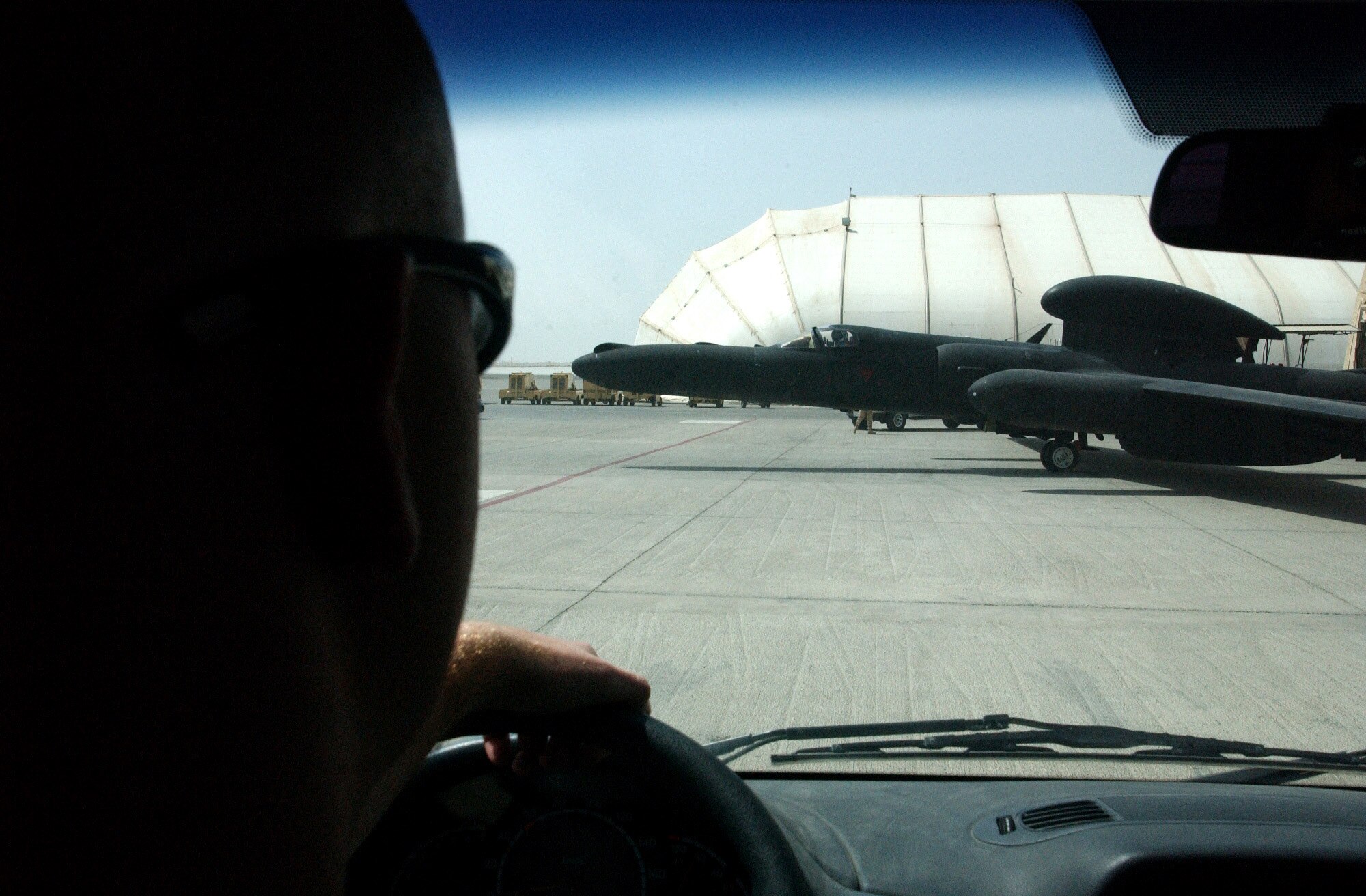 As Senior Airman Shawn Nyer watches, a U-2 piloted by Capt. Greg Hafner rolls out of its hangar at a forward-operating base in Southwest Asia Sept. 5. Airman Nyer helped Captain Hafner into the full-pressure suit and helmet needed for the mission. (U.S. Air Force photo/Master Sgt. Jason Tudor)
