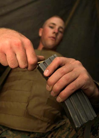Cpl. Matt Spiess, Marine Wing Support 171 aircraft rescue and firefighting specialist and native of Florence Mont., loads blanks before a quick reaction force patrol during Exercise Eagle Warrior, Sept. 6.