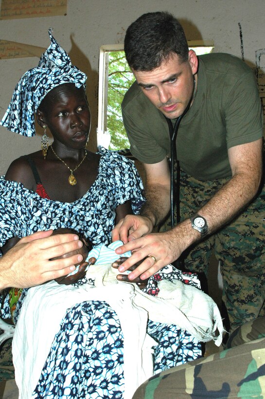 SAINT LOUIS, Senegal (Sept. 6, 2006) -- Lt. Cmdr. John Fortunato, a pediatrician with 4th Medical Battalion and resident of Salem, N.C. looks after an infant suffering from severe malnutrition during exercise MedFlag06. MedFlag is an annual U.S. European Command scheduled, joint and combined military exercise that took place Sept. 2-14.  The exercise aims to enhance the friendship with our African allies and provide an opportunity to train with foreign medical personnel.