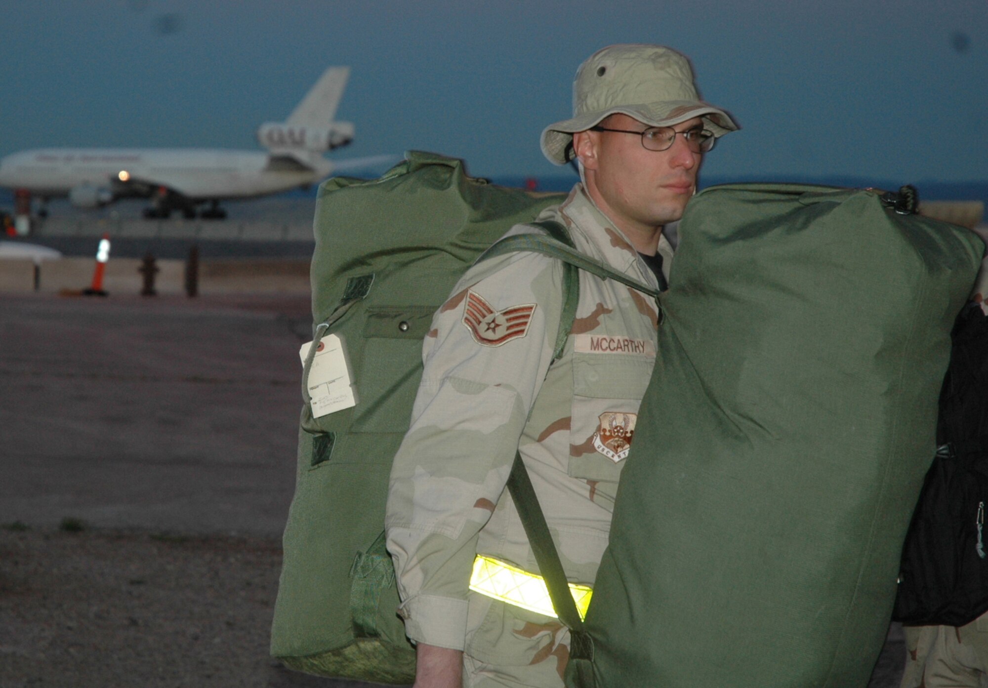 Heavy bags weigh Staff Sgt. Neil McCarthy as he gets ready to deploy from Ellsworth Air Force Base, S.D., in September. The Airman is a member of the 28th Munitions Squadron. More than 500 base Airmen left for duty in Southwest Asia to support operations in Iraq and Afghanistan. (U.S. Air Force photo/Airman Nathan Riley)
