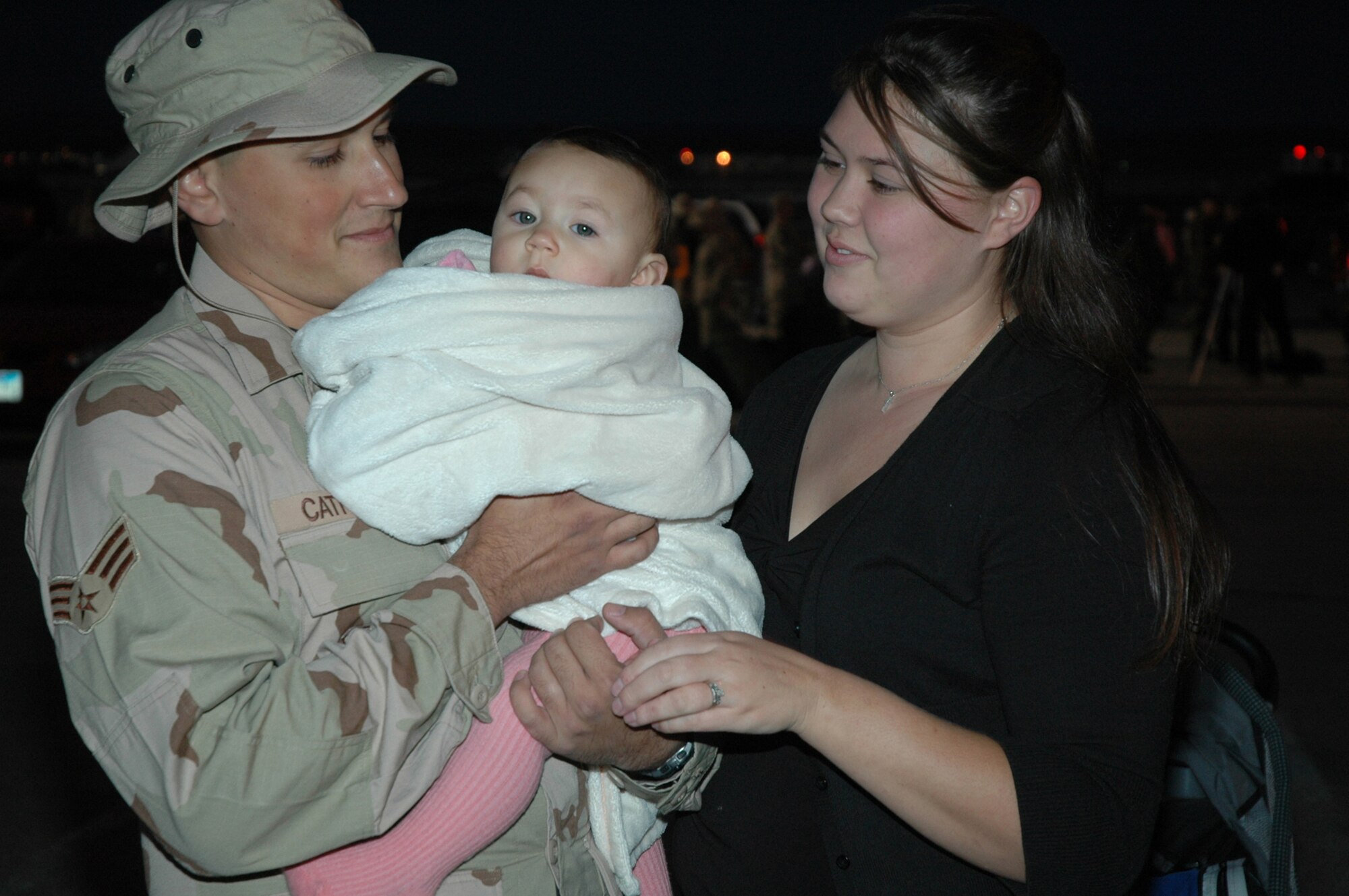 Senior Airman Anthony Cathcart, his wife, Jaclyn, and son, Payton, spend a few moments together before Airman Cathcart leaves for his deployment to Southwest Asia in September. (U.S. Air Force photo/Airman Nathan Riley)