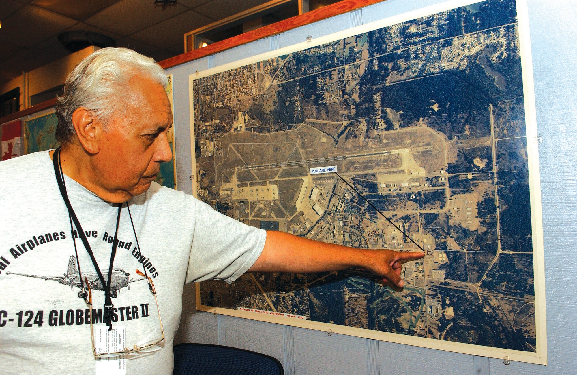MCCHORD AIR FORCE BASE, Wash. —
Museum volunteer Ed Baker highlights an aerial map of McChord. Mr. Baker has been involved with the museum since 1983. U.S. Air Force/Photo by Abner Guzman

