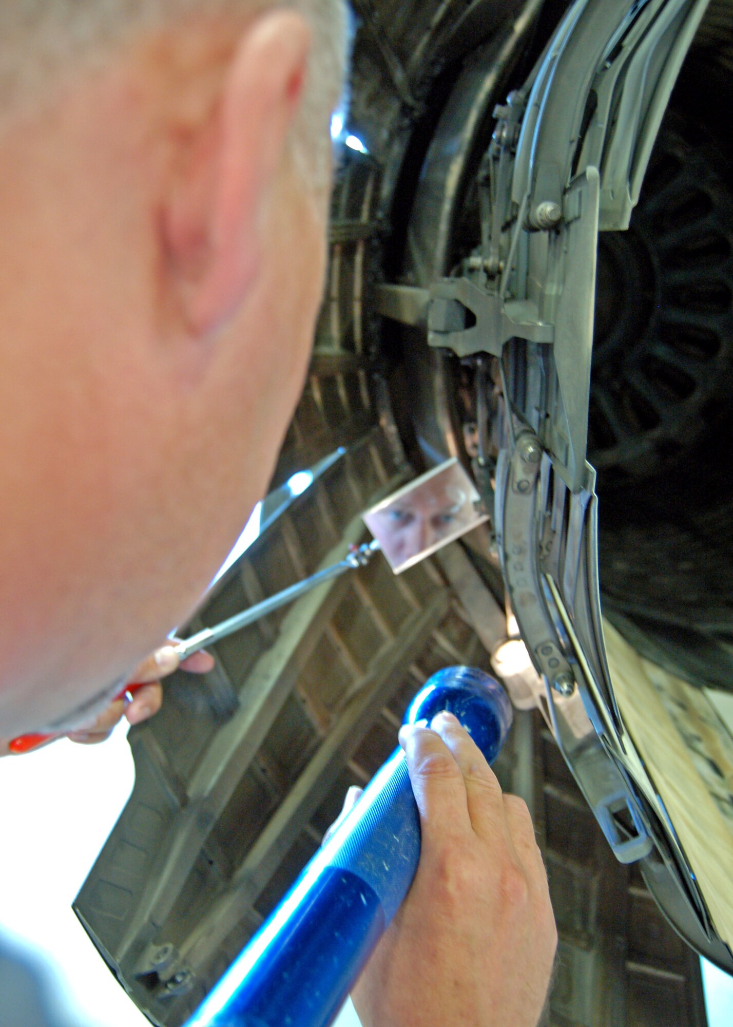 Tech. Sgt. Kenny Prather inspects the exhaust nozzle on an F-16 Fighting Falcon engine at Hill Air Force Base, Utah. Sergeant Prather is an Air Reserve Technician at the 419th Fighter Wing. He is also a civilian employee of the shop and has 18 years of active-duty and Reserve experience. (U.S. Air Force photo/G. A. Volb)