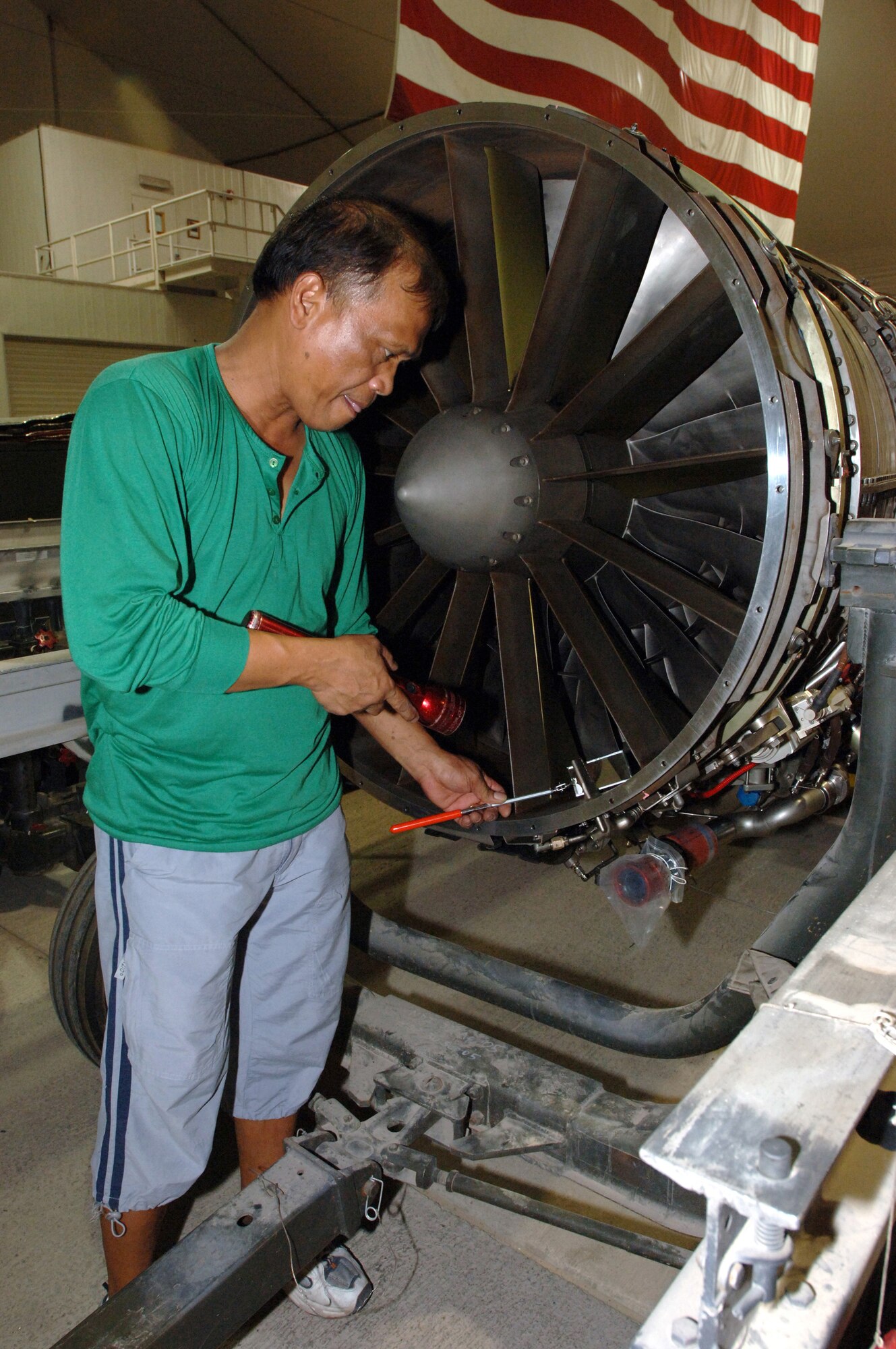 Ben Almazan, one of 19 Lockheed employees assigned to a forward-operating base in Southwest Asia, inspects a U-2 engine before an acceptance inspection by the Air Force quality assurance team. A U-2 receives a phase inspection every 400 hours. (U.S. Air Force photo/Staff Sgt. Alicia Flores)