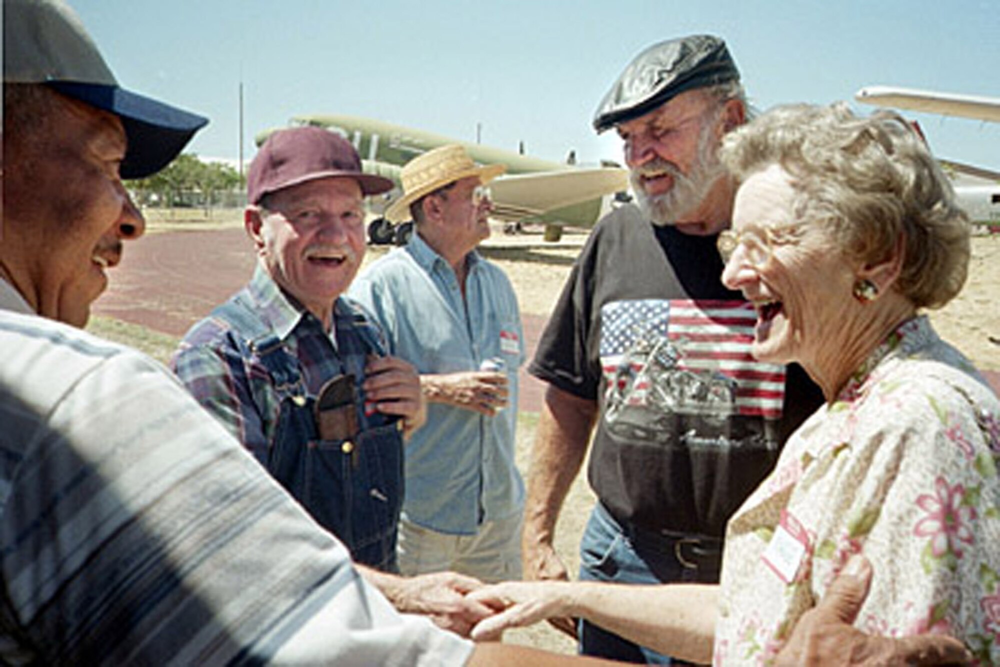 Crew Chief Gonza Hazel greets Loadmaster John King and DCM Secretary Marge Harris during the 9th Annual reunion and retiree picnic at the McClellan Aviation Museum in Sacramento Aug. 28, 2004. (U.S. Air Force photo/Chief Master Sgt. Kathryn Primrose)