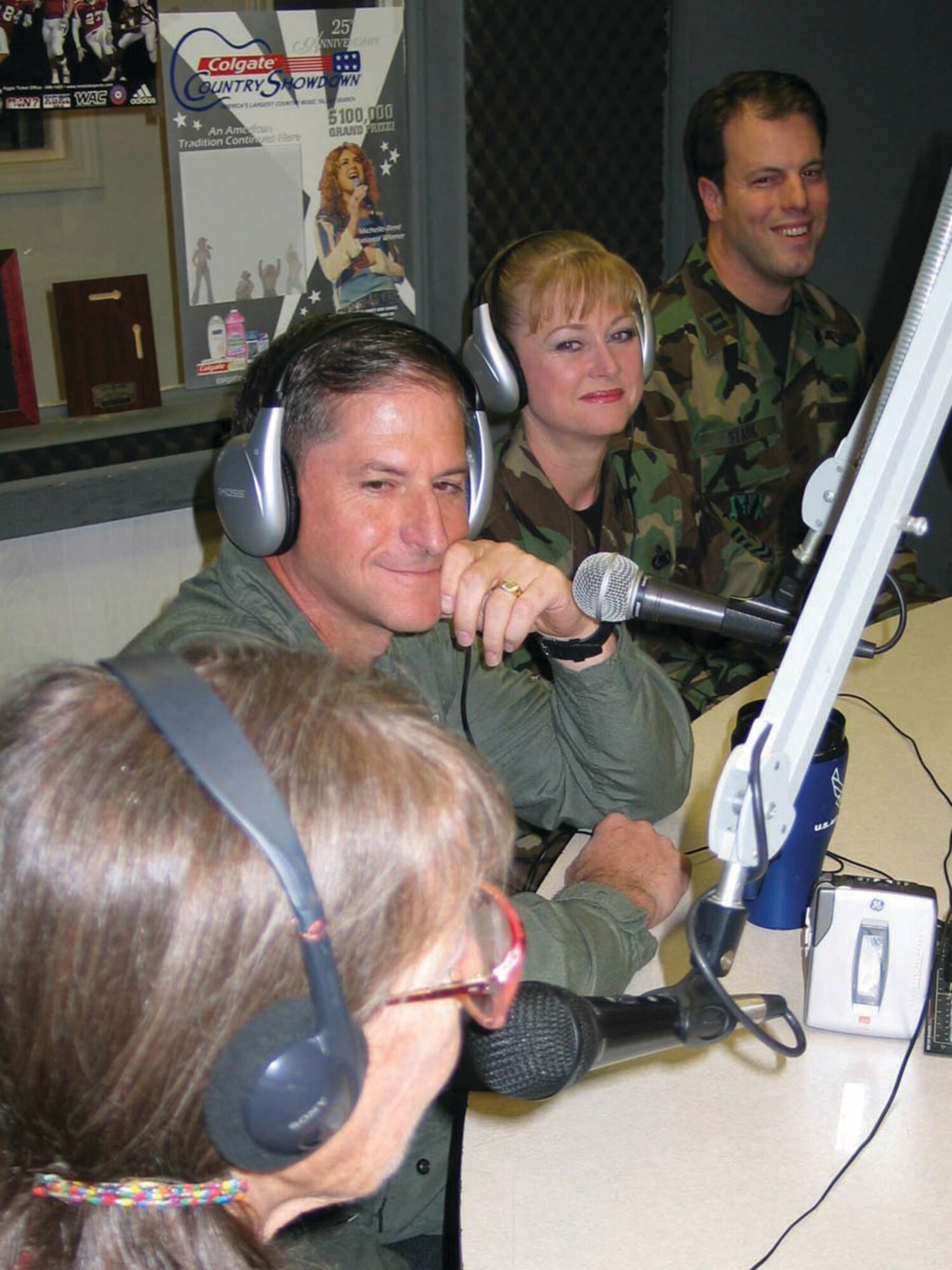 A light moment as Col. Dave Goldfein, 49th Fighter Wing commander, Chief Master Sgt. Marjorie McNichols, 49 FW command chief, and Capt. Joel Stark, 49 FW Public Affairs, discuss Holloman events with co-host Ms. Jean Vallance during a live radio interview at KRSY-FM in Alamogordo Aug. 29.