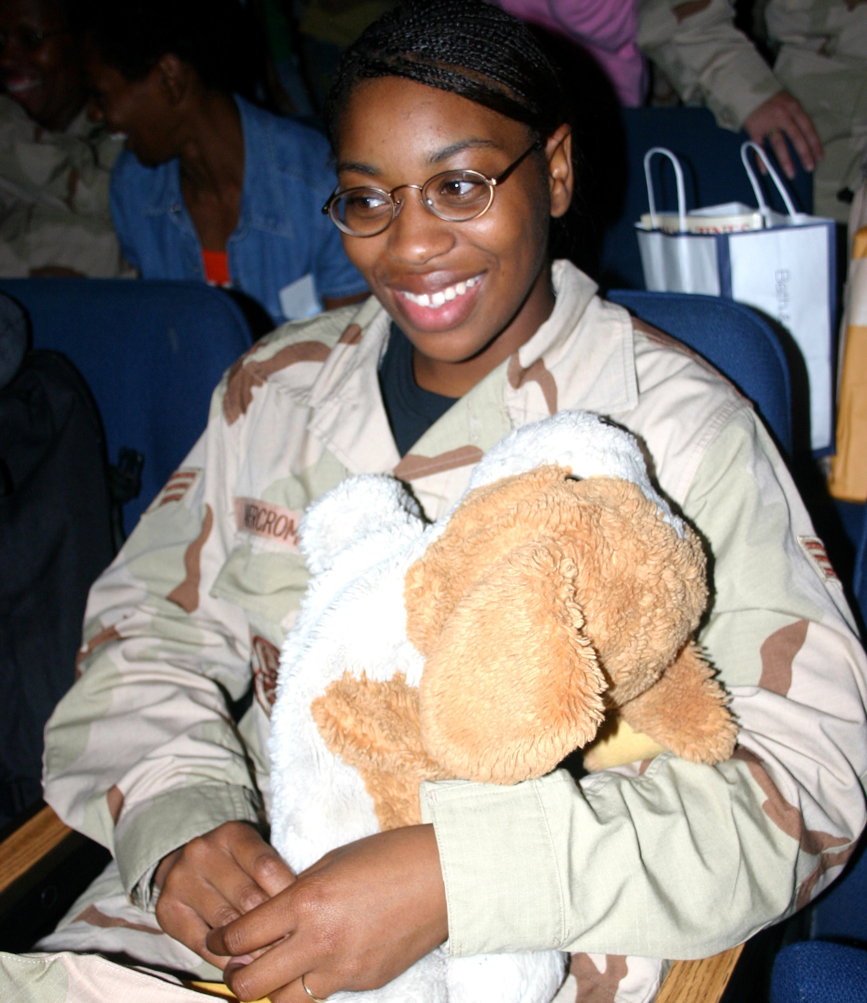 Senior Airman Dunyaska Abercrombie waits to board the plane that will take her and approximately 100 other deploying Airmen from the 59th Medical Wing at Lackland Air Force Base, Texas, to various locations in Southwest Asia. More than 200 Airmen are set to deploy from the base for Air Expeditionary Force 3 and 4. Airman Abercrombie is assigned to the 759th Surgical Operations Squadron. (U.S. Air Force photo/Master Sgt. Kimberly Spencer)