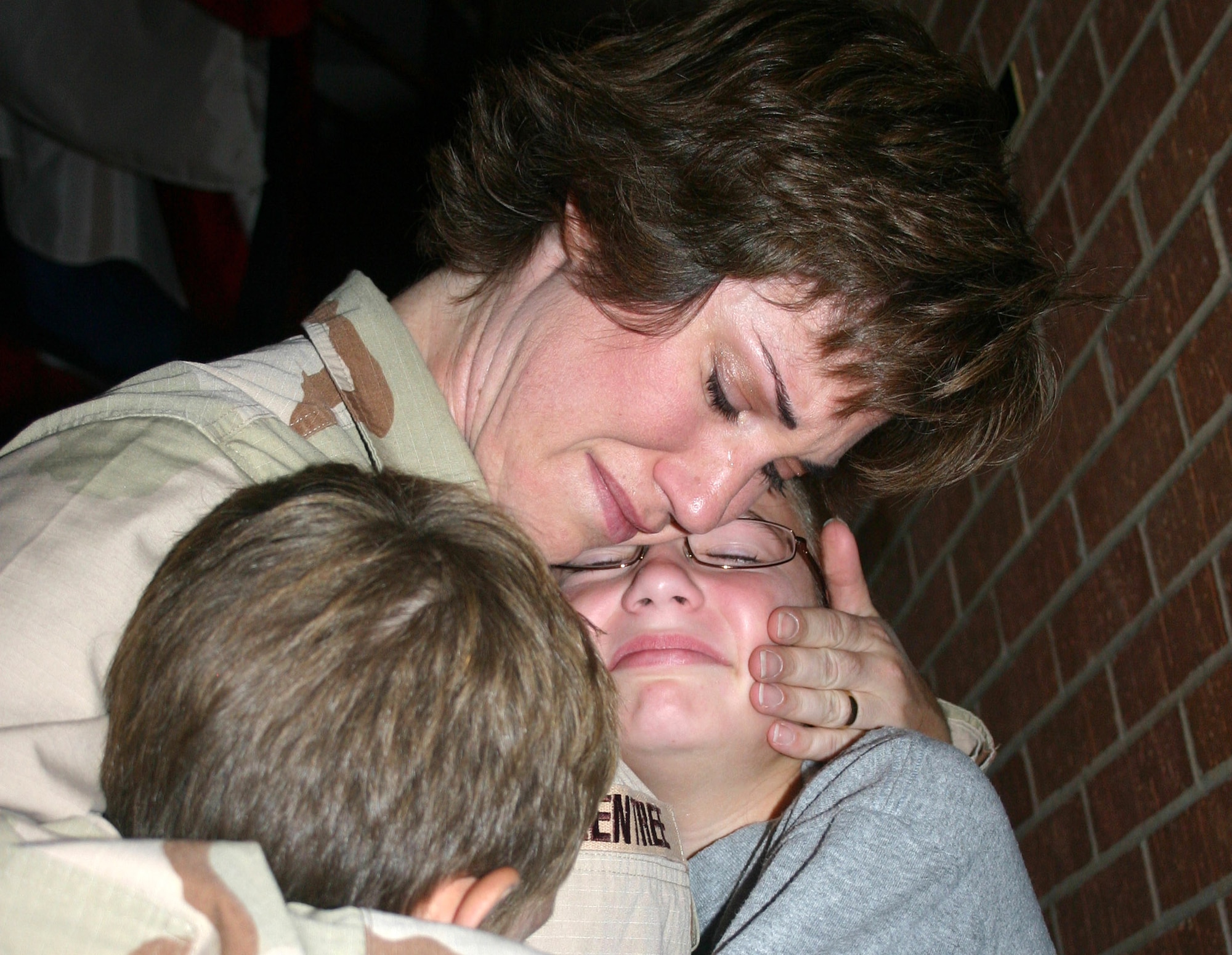 Maj. Cheryl Greentree comforts her daughter, Morgan, and son, Ryan, during the family's farewell at Lackland Air Force Base, Texas, in September. Approximately 100 Airmen from the 59th Medical Wing deployed in support of operations Enduring Freedom and Iraqi Freedom. Major Greentree is assigned to the 859th Surgical Operations Squadron. (U.S. Air Force photo/Master Sgt. Kimberly Spencer)