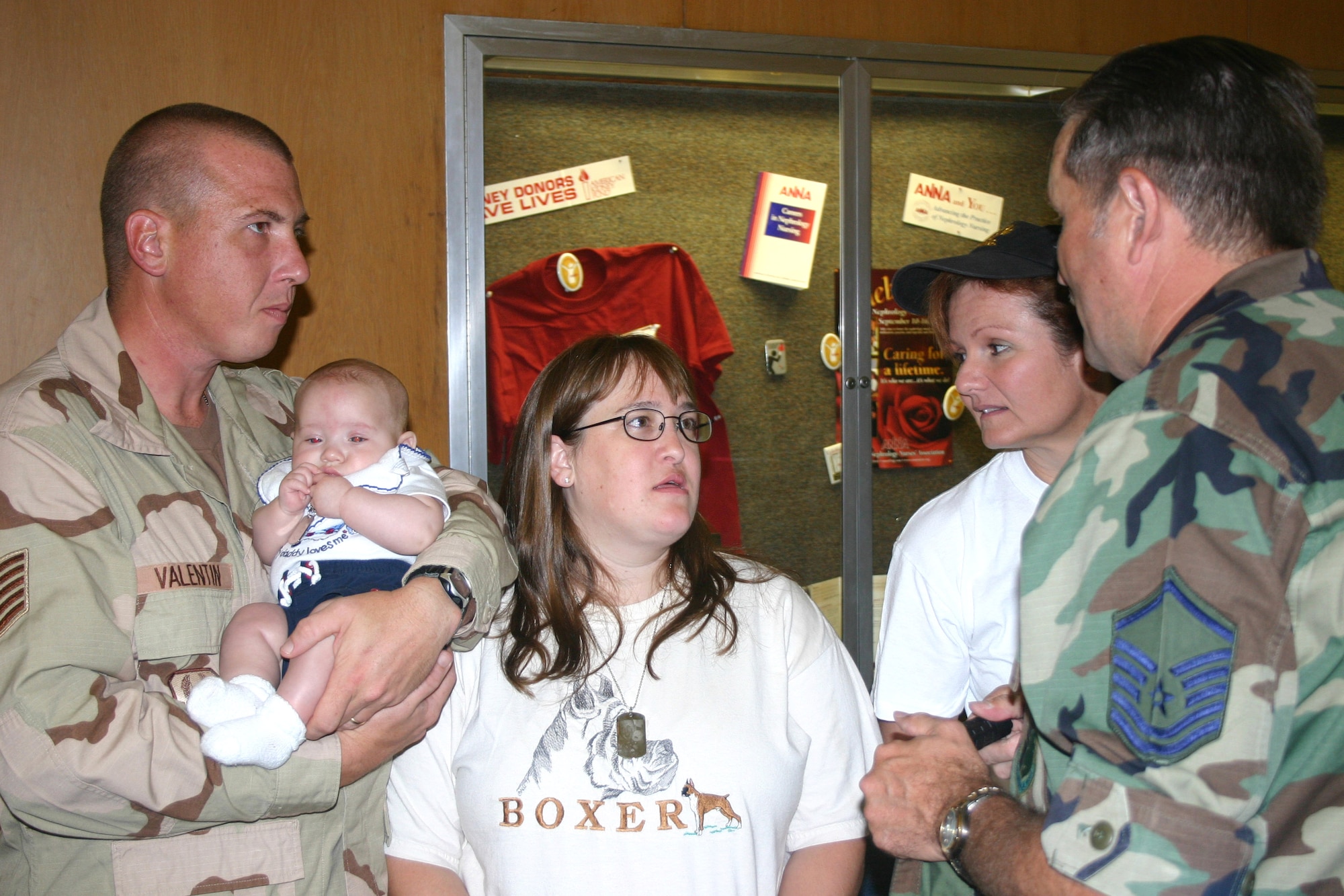 Tech. Sgt. Mike Valentin holds his 3-month-old son, Tyler, before departing for Balad Air Base, Iraq, in September. He is joined by his wife, Staff Sgt. Lorie Valentin, Capt. Marty Paul and Master Sgt. Thomas Eckhoff. Approximately 100 Airmen from the 59th Medical Wing at Lackland Air Force Base, Texas, deployed in support of operations Enduring Freedom and Iraqi Freedom. Sergeant Valentin is assigned to the 59th Medical Operations Squadron. (U.S. Air Force photo/Master Sgt. Kimberly Spencer) 
