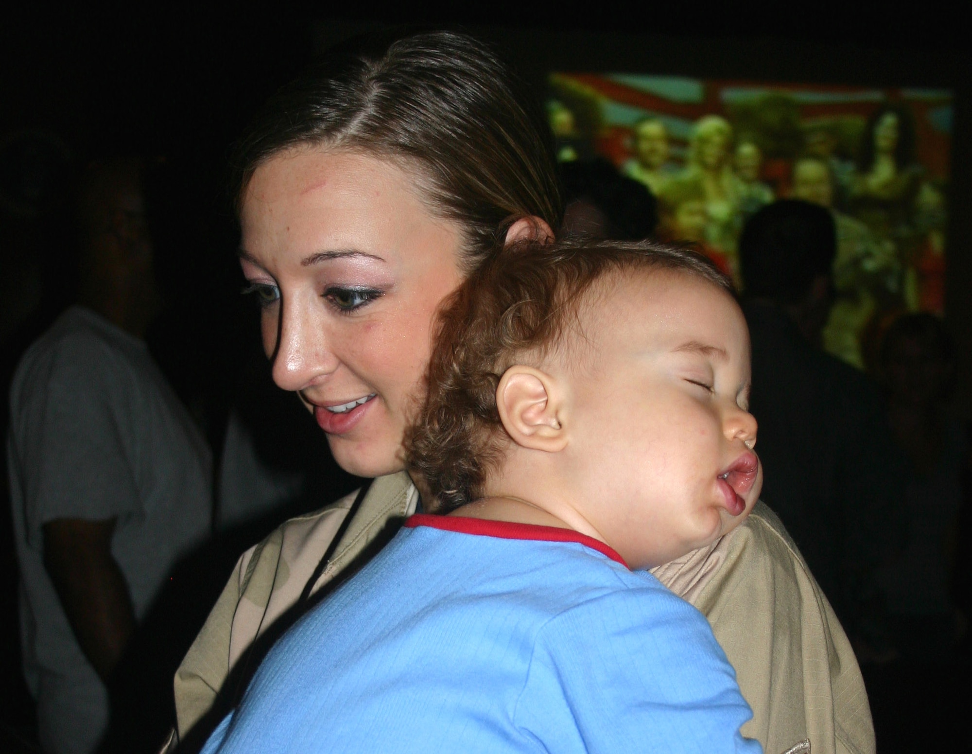 Staff Sgt. Marisa Burri holds her sleeping son, Xavier, as she visits with her family before leaving on deployment to Balad Air Base, Iraq, in September. Approximately 100 Airmen from the 59th Medical Wing at Lackland Air Force Base, Texas, deployed in support of operations Enduring Freedom and Iraqi Freedom. Sergeant Burri is assigned to the 59th Surgical Operations Squadron. (U.S. Air Force photo/Master Sgt. Kimberly Spencer) 
