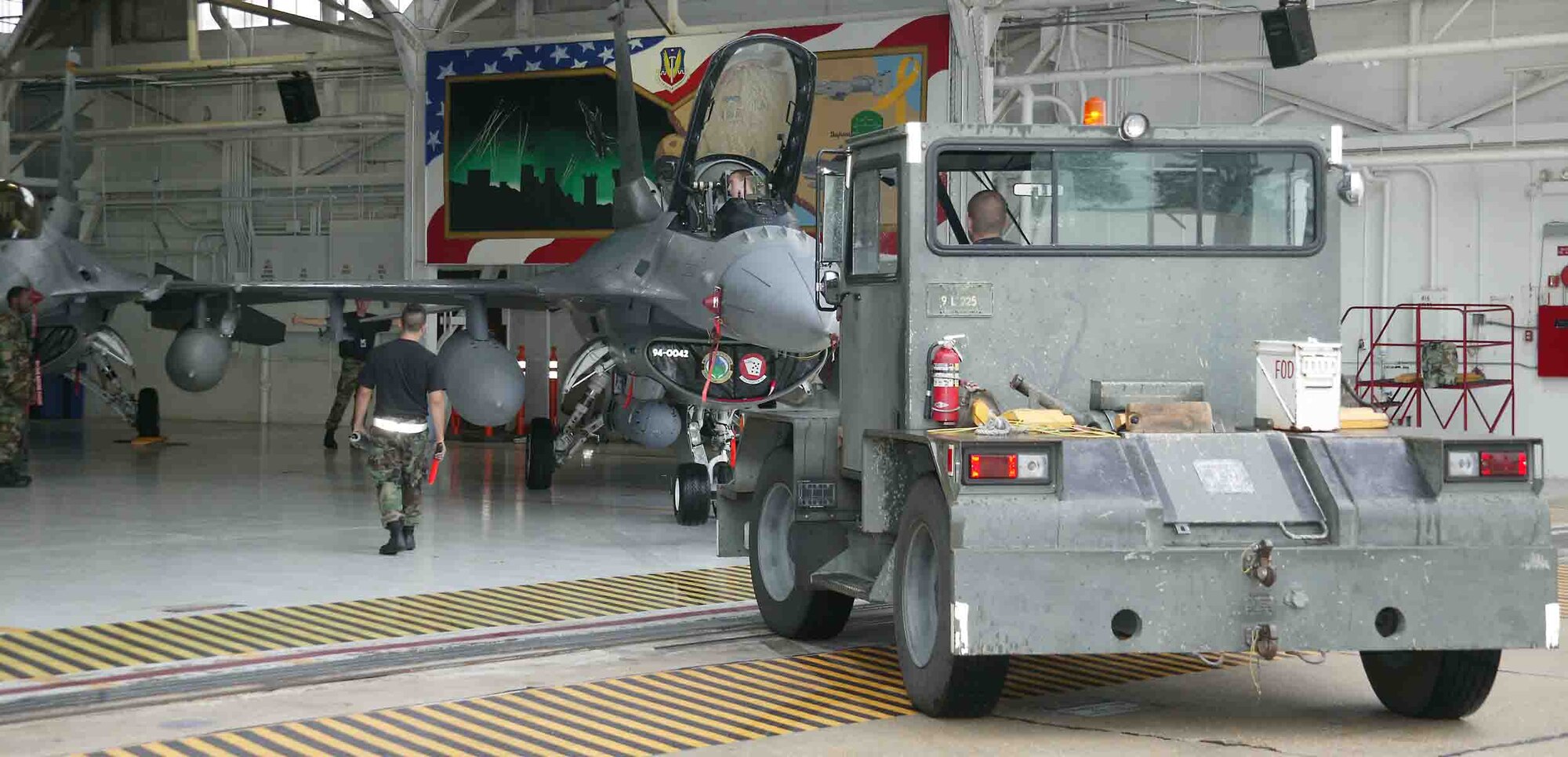 Shaw maintainers push an F-16 into Hangar 1200 in preparation for Tropical Storm Ernesto. (U.S. Air Force photo/Senior Airman John Gordinier)