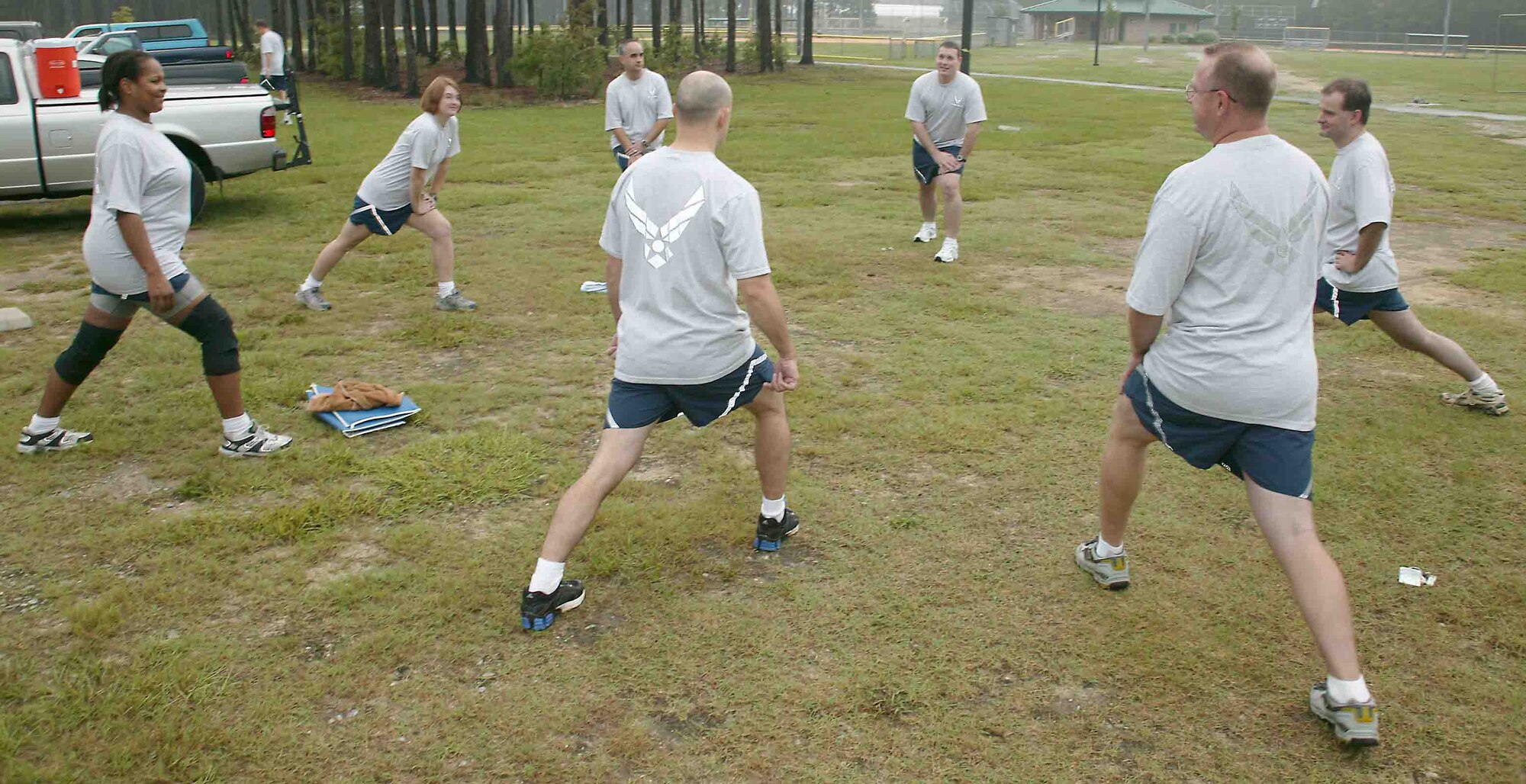 SHAW AIR FORCE BASE, S.C.-- Members from the 609th Air Intelligence Group stretch prior to a workout Wednesday at the outdoor recreation sports complex. PT wear is mandatory during unit physical training after Sept. 30. (U.S. Air Force photo/Senior Airman John Gordinier)