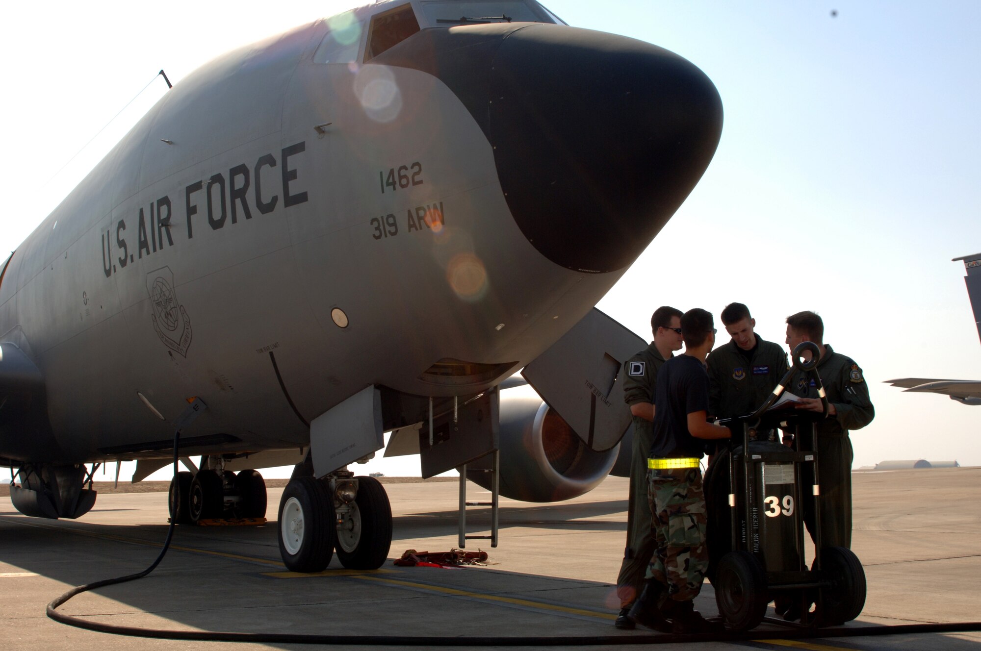 Members of the 90th EARS talk about their preflight inspection before taking off on a mission Sept. 5. (U.S. Air Force photo by Airman 1st Class Nathan Lipscomb)