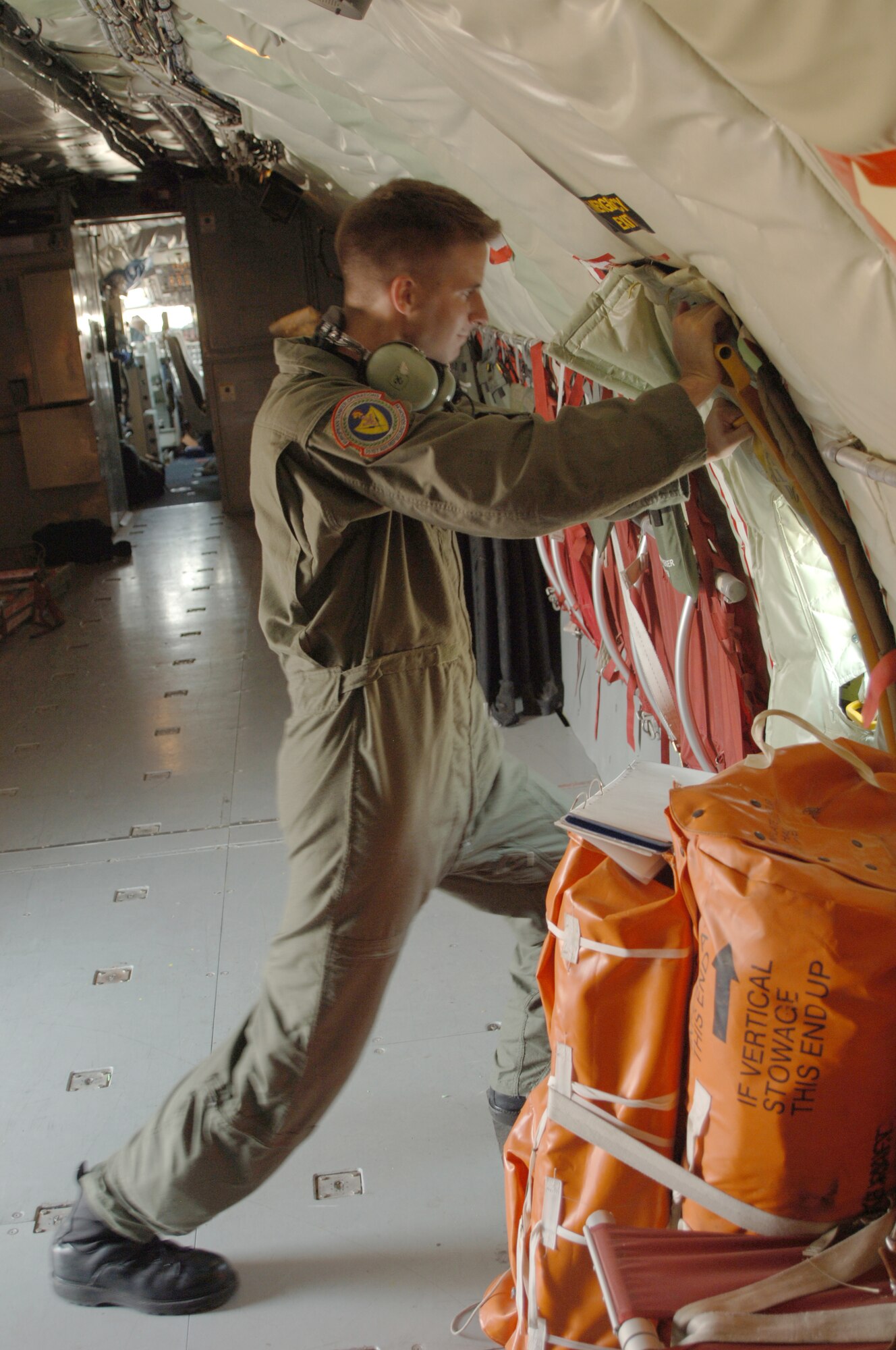 Senior Airman Thomas Nance puts up an insulation panel inside of a plane on Sept. 5. Airman Nance is part of the 90th Expeditionary Air Refueling Squadron. (U.S. AIr Force photo by Airman 1st Class Nathan Lipscomb)