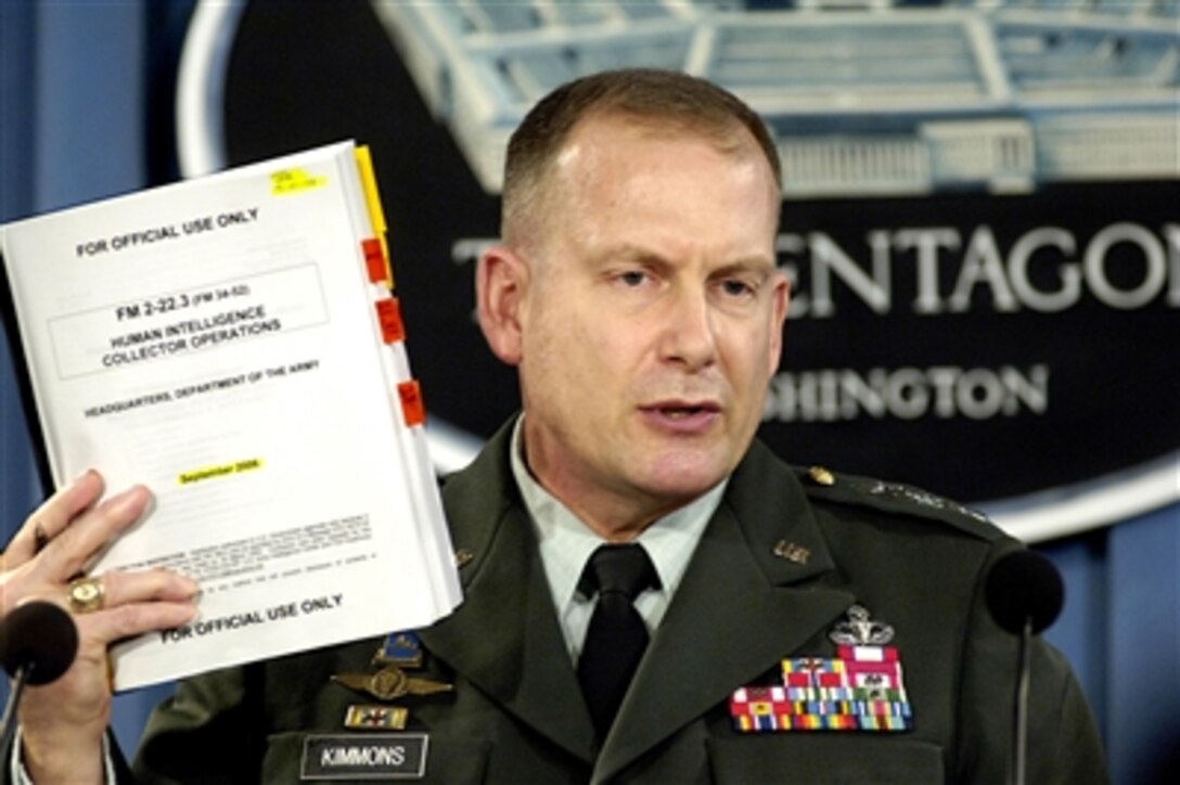 U.S. Army Lt. Gen. John Kimmons holds up a copy of Army Field Manual, FM 2-22.3, Human Intelligence Collector Operations as he briefs reporters on the details of the manual in the Pentagon on Sept. 6, 2006.  