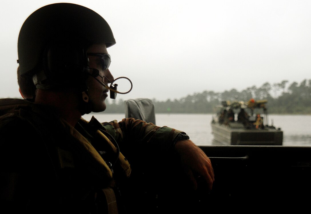 MARINE CORPS BASE CAMP LEJEUNE, N.C. - Petty Officer 1st Class Michael Beane, student participating in the culminating exercise of the Riverine Coxswain's and Boat Captain's Course, surveys the water as his riverine assault craft makes its way down the Cape Fear River Sept. 6. Sixty sailors from various active duty units participated in the final exercise conducted by the Marines with Special Missions Training Center here Sept. 6-14 in preparation for the Navy's take over of Marine Corps river operations in Iraq next year. (Official U.S. Marine Corps photo by Lance Cpl. Brandon R. Holgersen)(released)