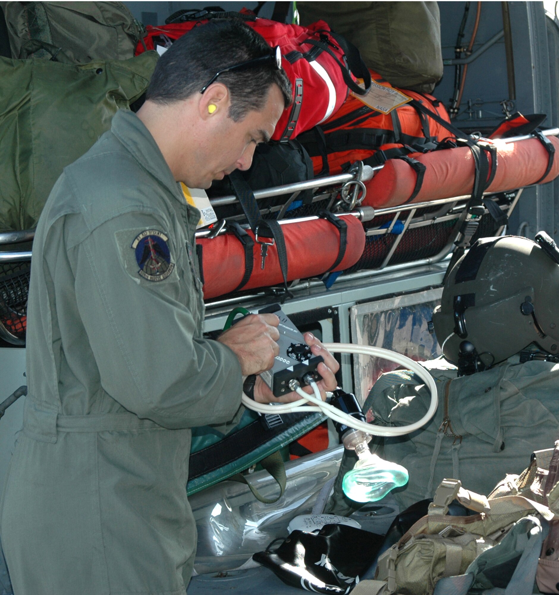 MSgt. Troy Long, 920th pararescueman, preps medical equipment on an HH-60G prior to suppoting the launch of Space Shuttle Atlantis.