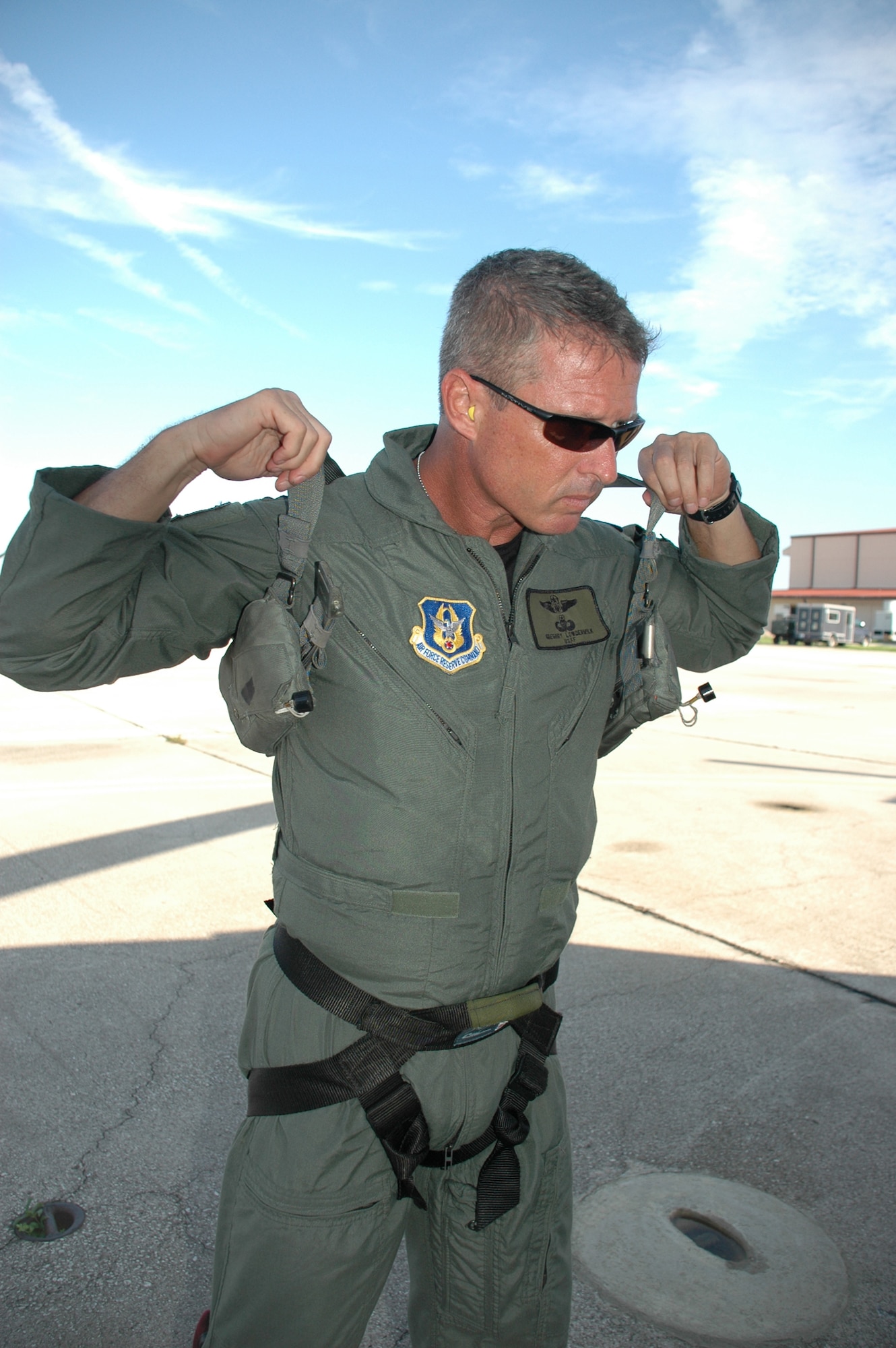 Capt. Greg Lowdermilk, 920th Combat Rescue Officer, dons his rescue gear prior to boarding an HH-60G Pavehawk in support of astronaut recovery efforts prior to Space Shuttle Atlantis launch.