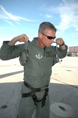 Capt. Greg Lowdermilk, 920th Combat Rescue Officer, dons his rescue gear prior to boarding an HH-60G Pavehawk in support of astronaut recovery efforts prior to Space Shuttle Atlantis launch.