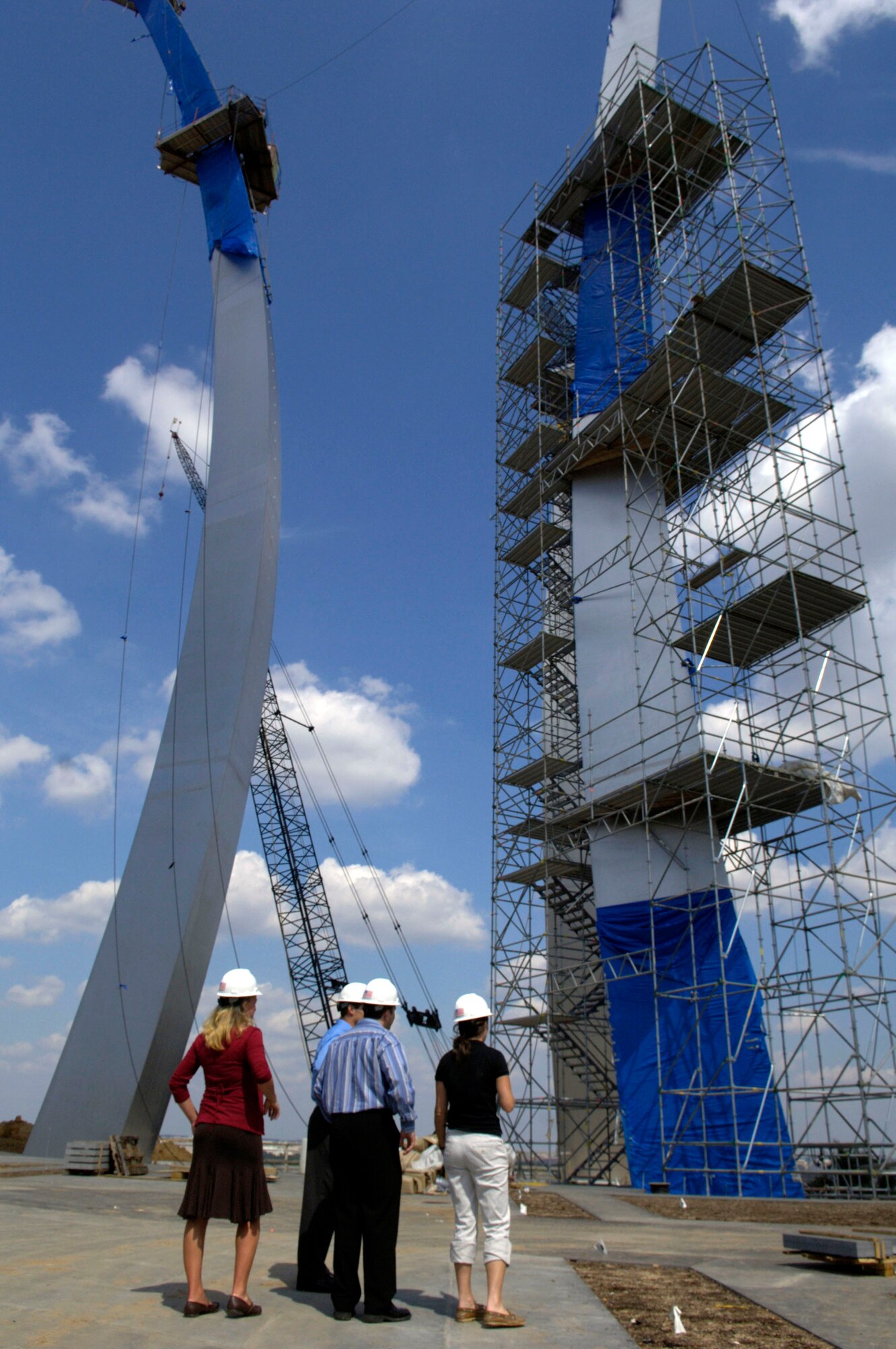 Team Air Force from the "Treasure Hunters" reality television show receives a tour of the new Air Force Memorial site by Katie Martha, a public affairs executive with the Air Force Memorial Foundation, during their visit Sept. 7. The team, Air Force Academy graduates Matt Zitzlsperger and husband and wife, Matt and Brooke Rillos, placed second in the show competition. (U.S. Air Force photo/Tech. Sgt. Cohen A. Young) 