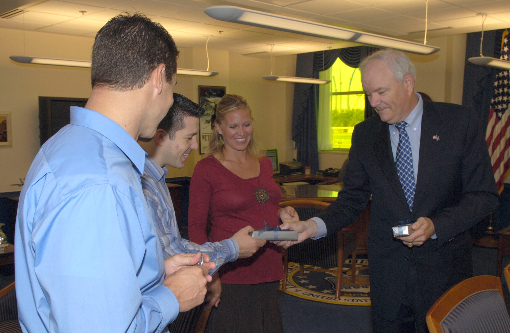 Secretary of the Air Force Michael W. Wynne meets Team Air Force from the "Treasure Hunters" television show, Matt Zitzlsperger and husband and wife, Matt and Brooke Rillos, and presents them with Air Force mementos during their visit to the Pentagon Sept. 7. The three placed second on the show. The team also met Air Force Chief of Staff Gen. T. Michael Moseley and visited the site of the new Air Force Memorial. (U. S. Air Force photo/Tech. Sgt. Cohen A. Young)