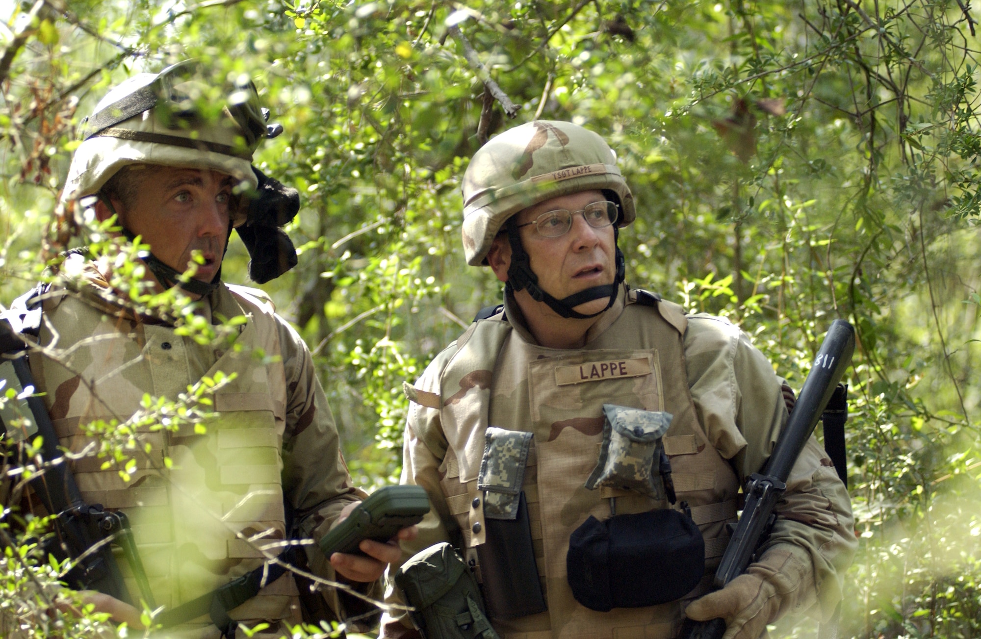 Master Sgt. Jim Clifton (left) and Tech. Sgt. Gene Lappe find a land navigation point Aug. 30 utilizing the techniques they learned at Camp Shelby, Miss.  Camp Shelby is one of several Army installations providing training to military personnel preparing to deploy to Southwest Asia.  (U.S. Air Force photo/Tech. Sgt. Cecilio Ricardo Jr.)