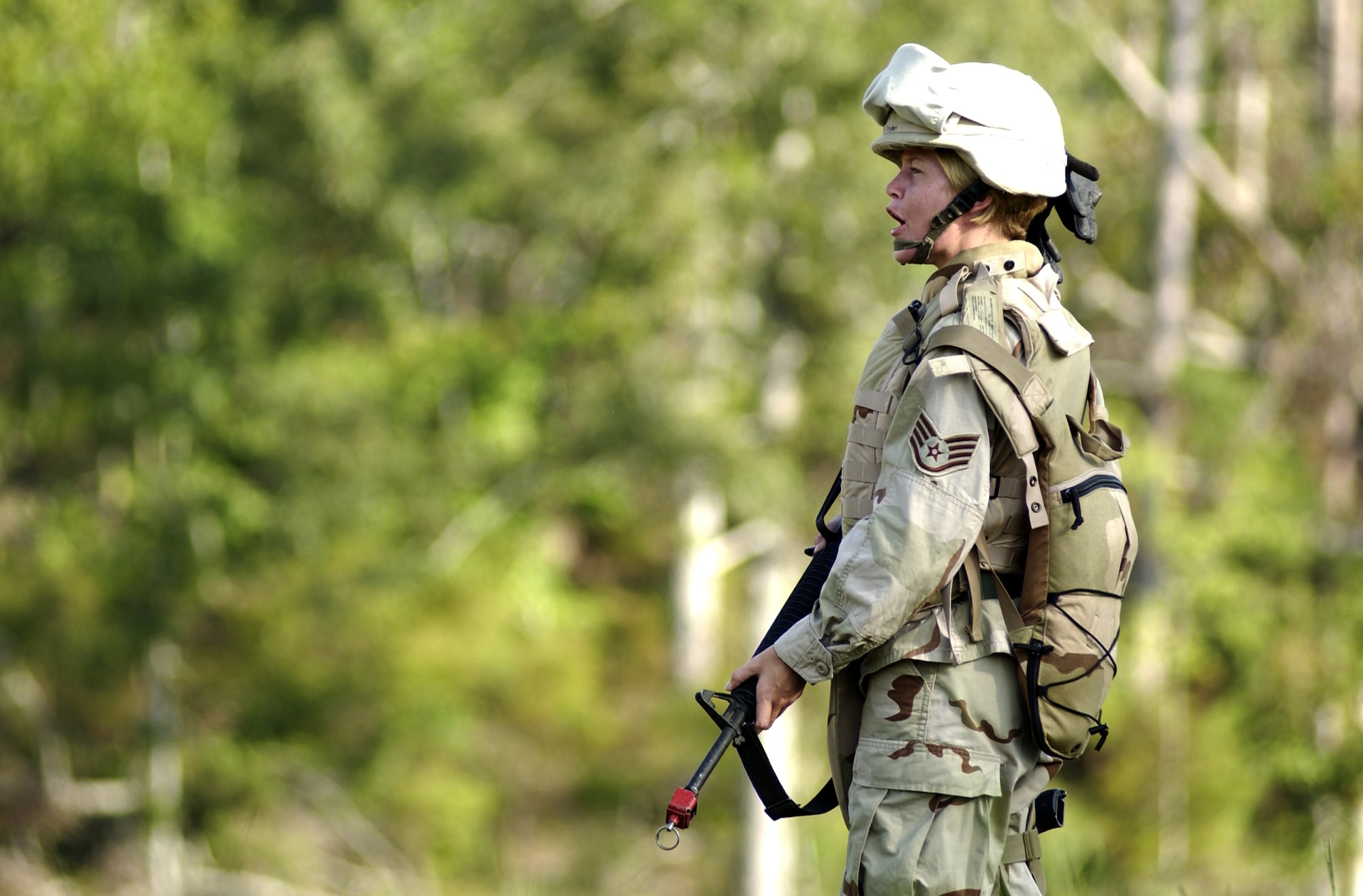 Staff Sgt. Laura Dryden sounds off after her team finds another location using the land navigation techniques taught to them during in-lieu-of training Aug. 30 at Camp Shelby, Miss.  Camp Shelby is one of several Army installations providing training to military personnel preparing to deploy to Southwest Asia.  (U.S. Air Force photo/Tech Sgt. Cecilio Ricardo Jr.)