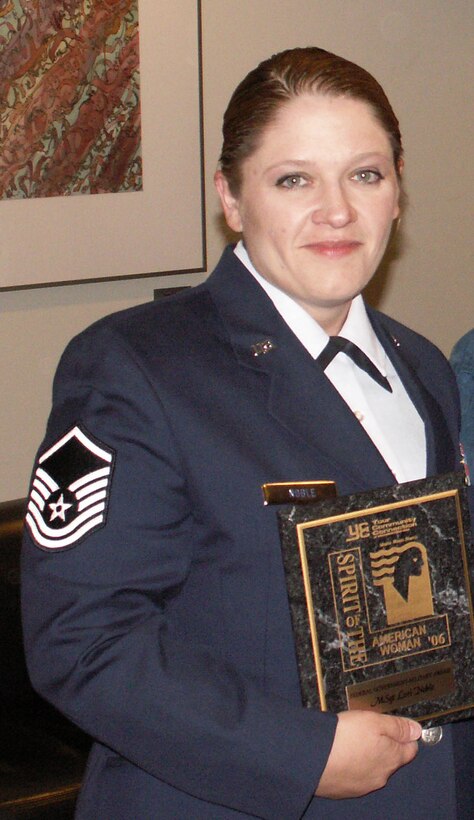 U.S. Air Force Reservist Master Sgt. Lori Noble holds her "Spirit of the American Woman Award she recieved for being an amazing role model. (U.S. Air Force Photo/Senior Airman Christina Wright)