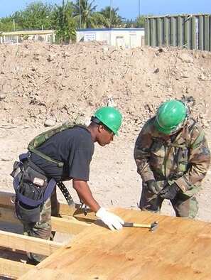 U.S. Air Force Reservists Master Sgt. Michael Martinez, members of the 419th Fighter Wing Civil Engineering Squadron Prime BEEF team, build a wood floor for the base's new hospital tent. (U.S. Air Force Photo)