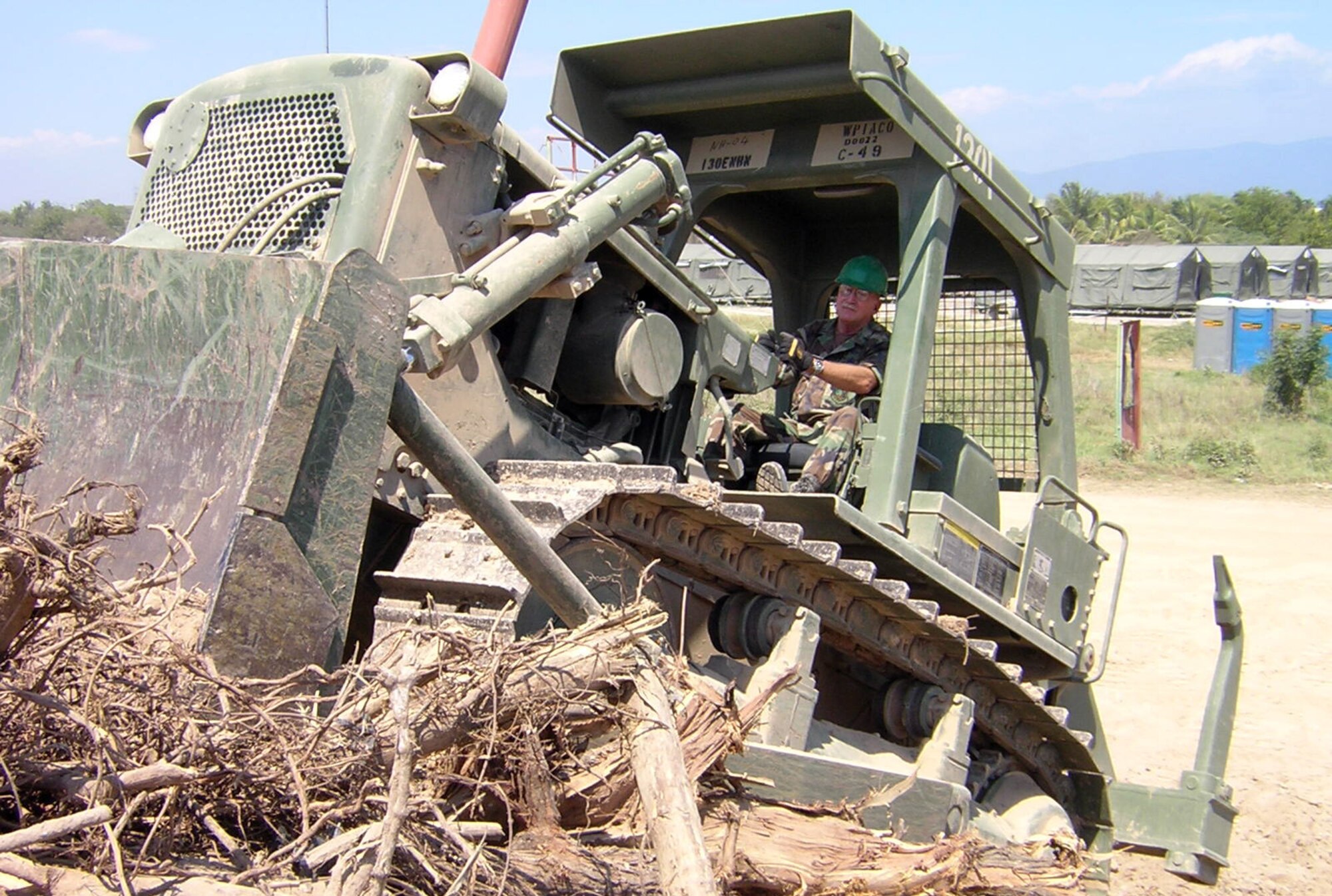 U.S. Air Force Reservist Master Sgt. Paul Squires, 419th Fighter Wing Civil Engineer Squadron Prime 'BEEF' team, clears debris from an abandoned runway during a recent deployment to the Dominican Republic. The Team built a tent City that will house humanitarian aid facilties to help local residents recovering from a severe hurrican that hit the region nearly two years ago. (U.S. Air Force Photo)
